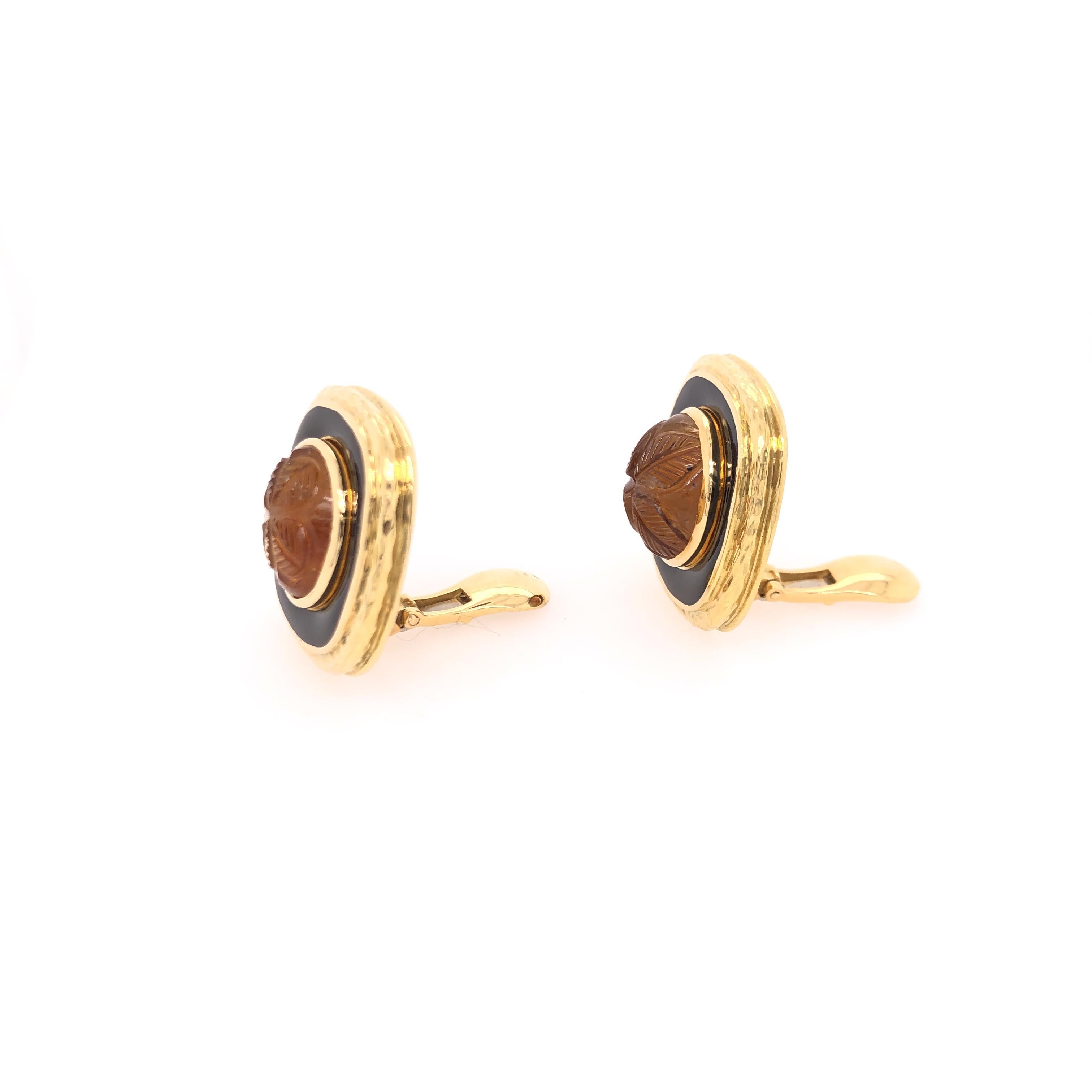 Floral motif carved topaz set in 18K yellow gold and black enamel. Wonderful for everyday wear and business attire. 

From the Skibell Estate Collection 

Stamped: ©WEBB 18K

 