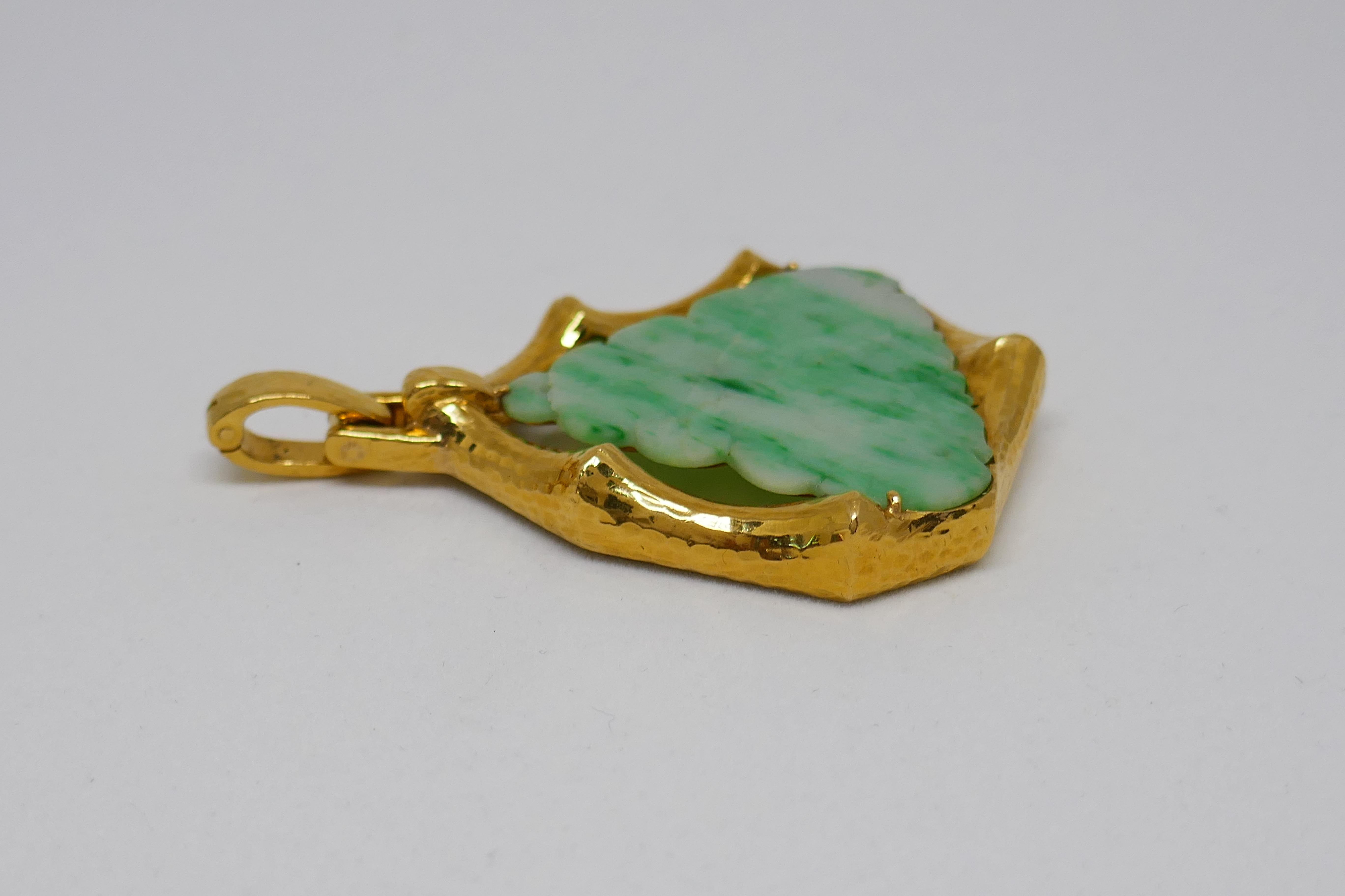 Lovely vintage carved jade pendant created by David Webb. 
The pendant is made of 18 karat (stamped) yellow gold and carved jade. It measures 2 x 1-3/4 inches (5 x 4.5 cm) without bail and 2-1/2 inches (6.5 cm) long with the bail. The pendant weighs