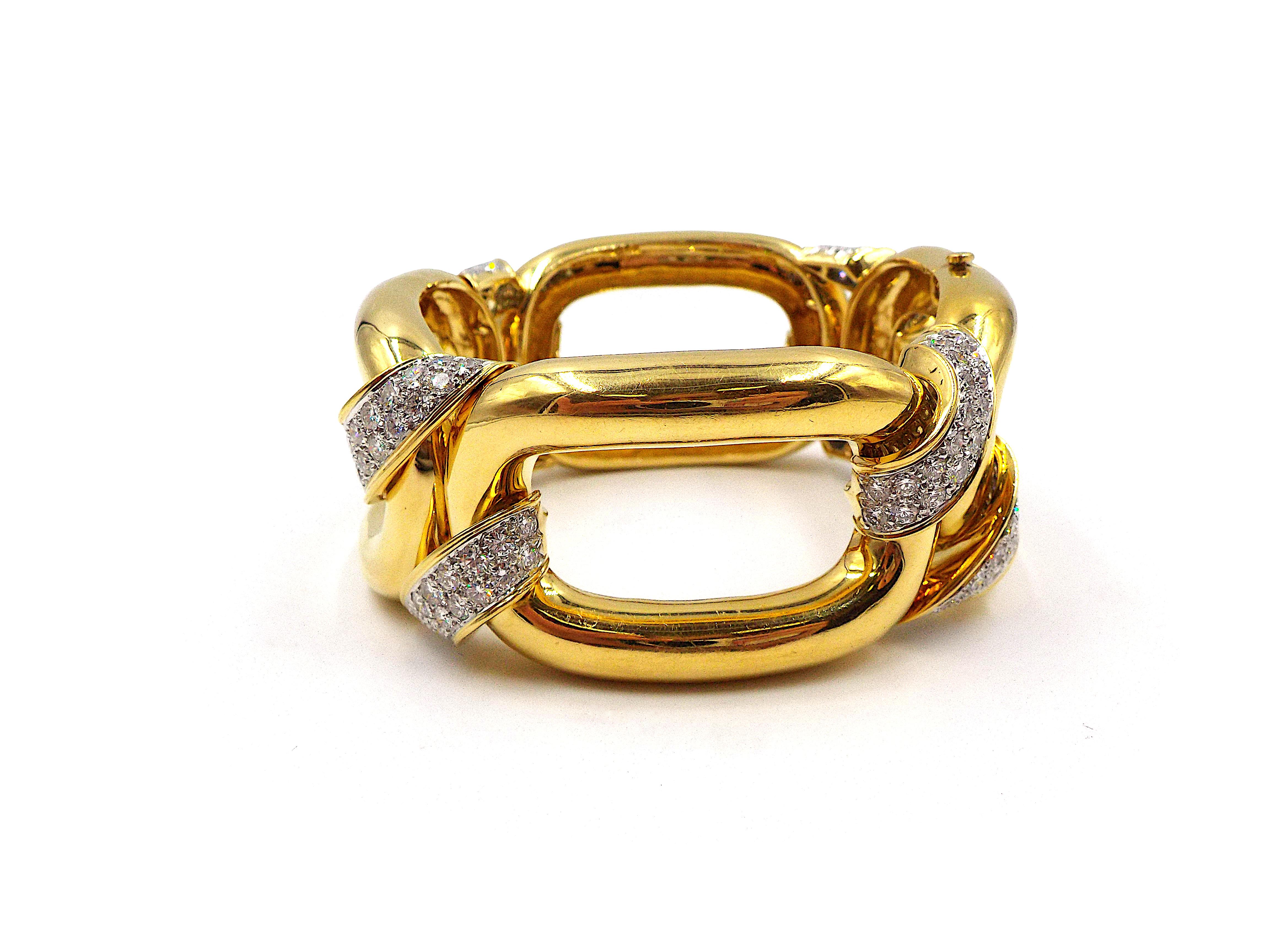 A chic and stylish statement bracelet by David Webb. Performed in 18K yellow gold and platinum, designed as a series of oversized links connected by platinum segments inlaid with ap. 8ct of diamonds. Signed David Webb, stamped 18K PLAT. Inner