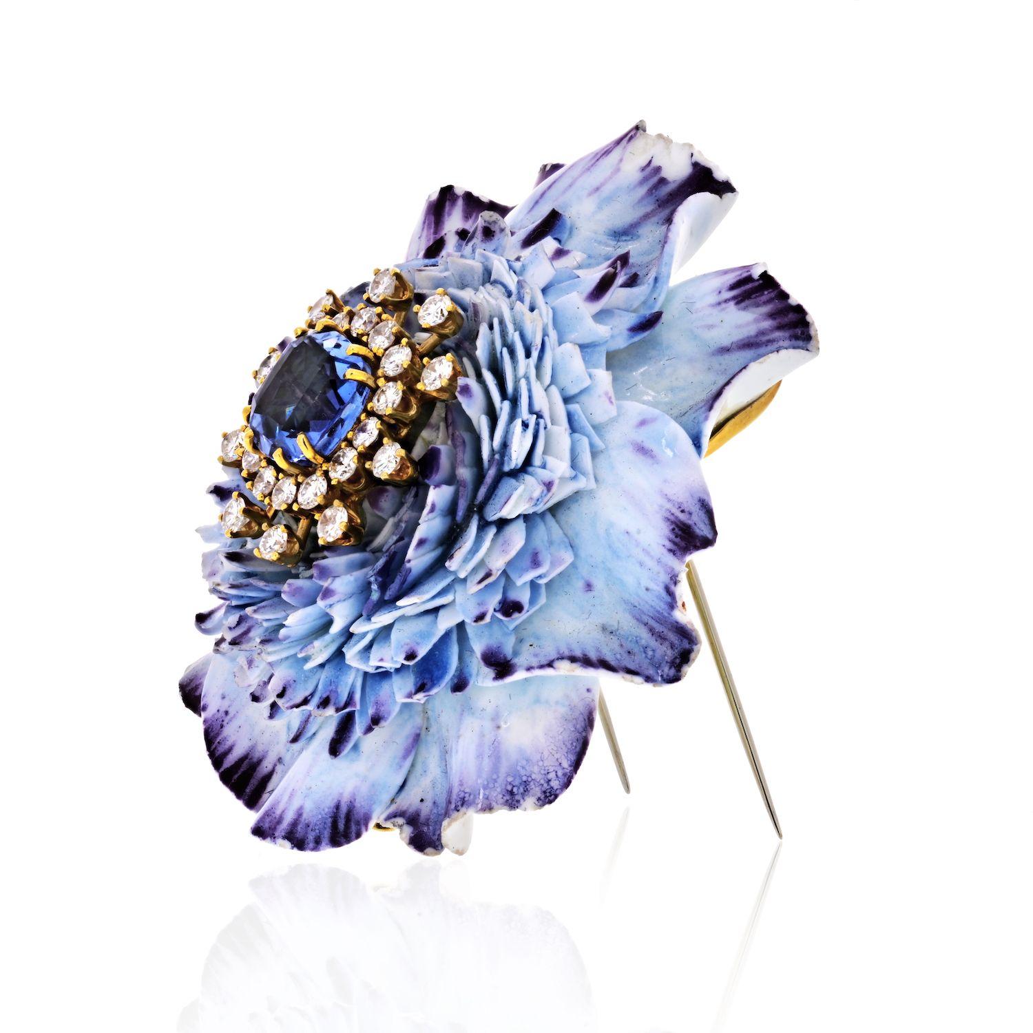 A superbly carved frosted ceramic flower with a cushion-cut sapphire in the center.  The flowerhead is embellished with diamonds and offers a beautiful glitter like effect to center sapphire. 
This brooch has a soft blue hue producing an adequate