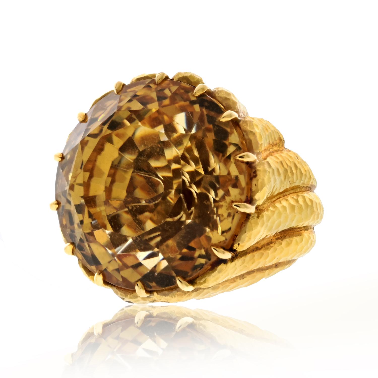 This estate David Webb cocktail ring is an exquisite blend of timeless design and craftsmanship. The focal point of this elegant piece is a stunning 24mm wide citrine gemstone. Set in a luxurious combination of platinum and 18K yellow gold, this