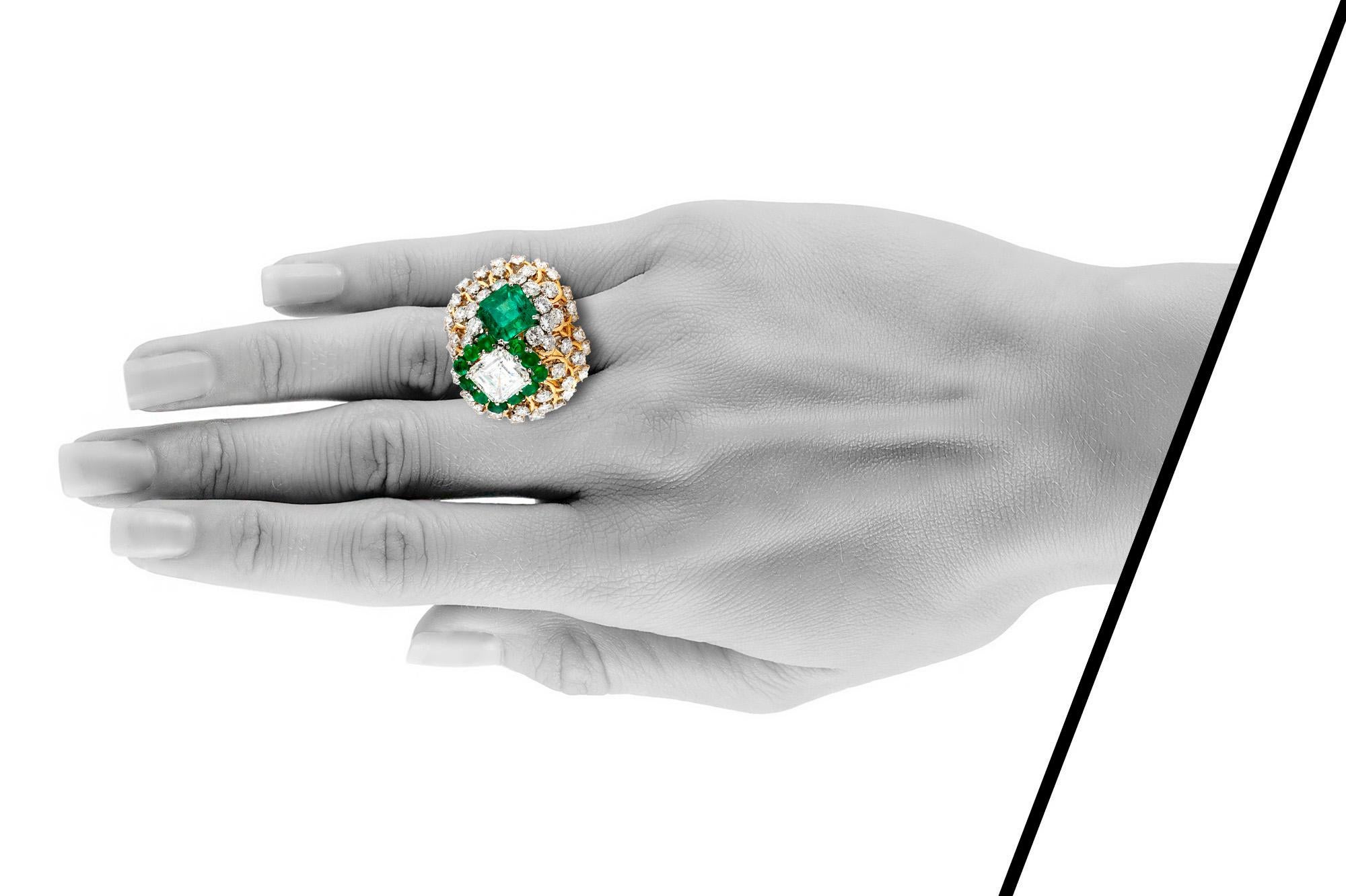 David Webb cocktail ring, finely crafted in 18 k yellow gold and platinum, featuring 3.10 Carat Asscher cut-diamond; GIA certified G color and VS2 clarity, and 4.43 carat Emerald cut emerald; AGL certified. The two stones are accented with round