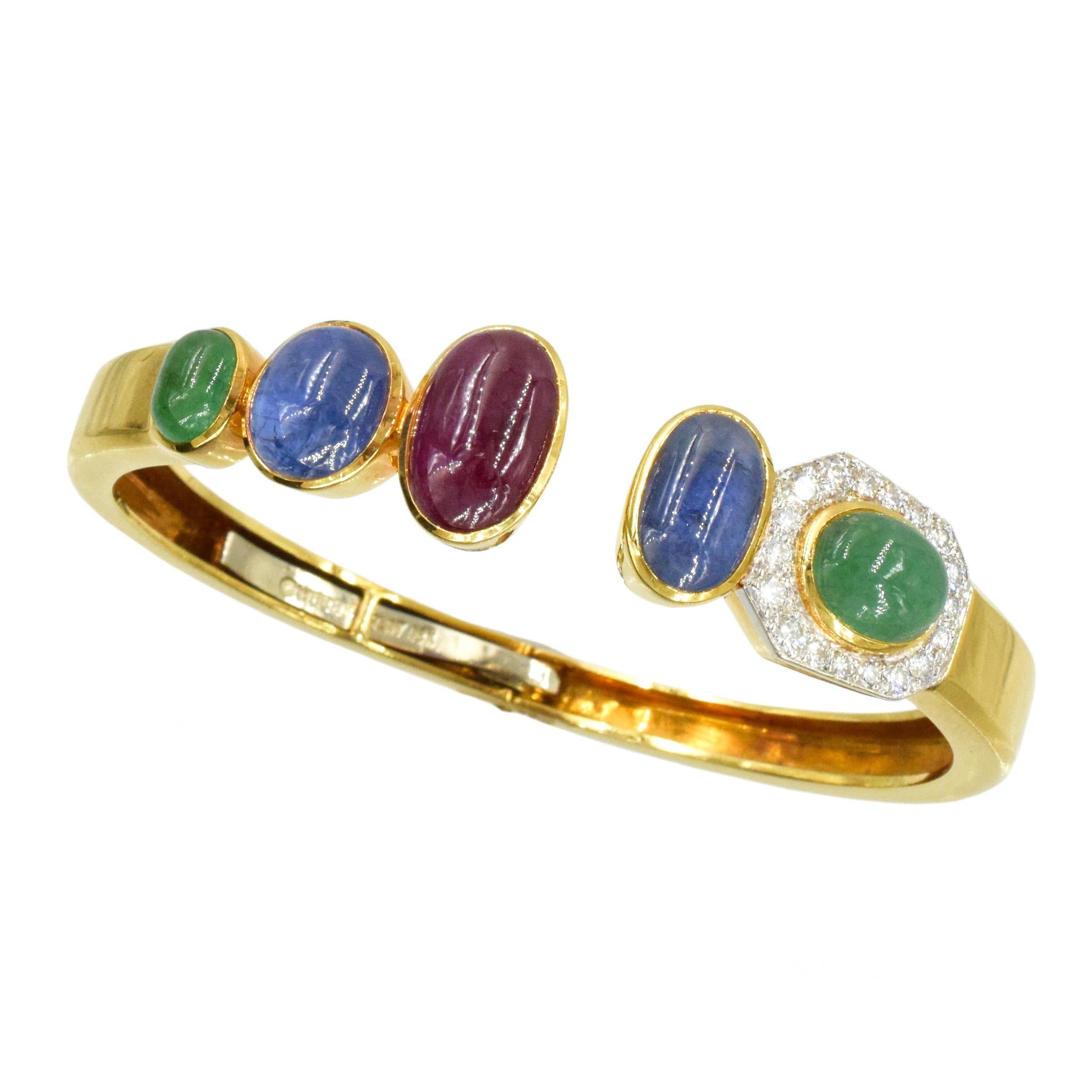 David Webb Gold, Platinum, Cabochon Colored Stone an Diamond Bangle Bracelet This polished bangle asymmetrically topped by one oval cabochon ruby and 4 sapphires and
emeralds, one of the emeralds framed by 18 round diamonds ap. .60 carats
signed