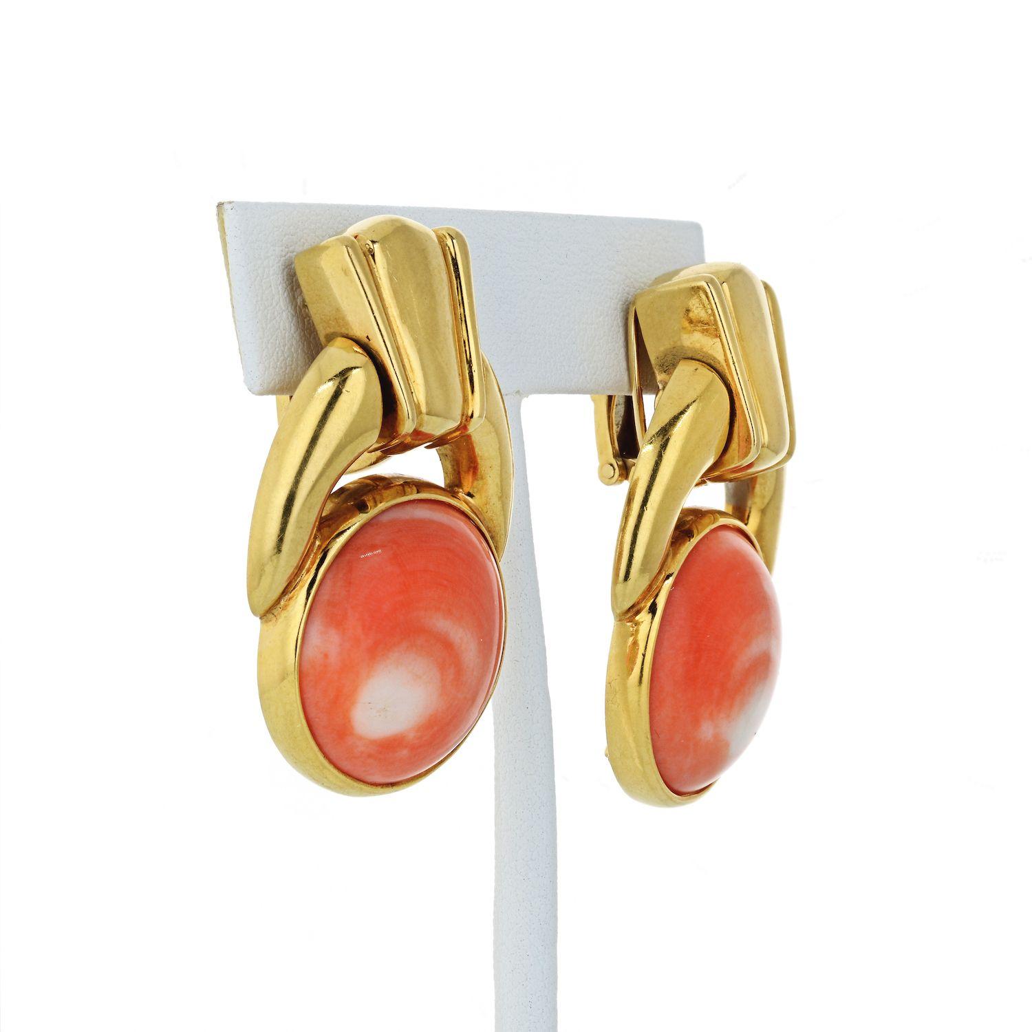 Of door knocker design, each earring features a round coral cabochon mounted in 18K yellow gold; each earring measures 4.0 x 2.6 cm; weight 43.0g. Signed WEBB; Stamped 18K. 
