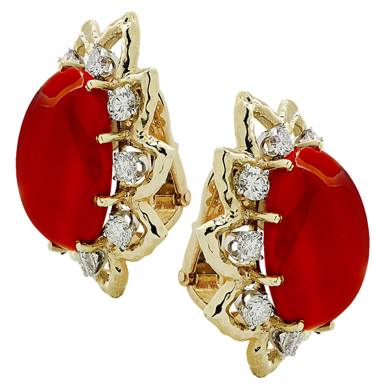 Spectacular David Webb Coral and Diamond clip on earrings crafted in 18 karat yellow and white gold, showcasing 2 exquisite ox blood coral cabochons and 18 round brilliant cut diamonds weighing approximately 3.24 carats total, G color, VS clarity.