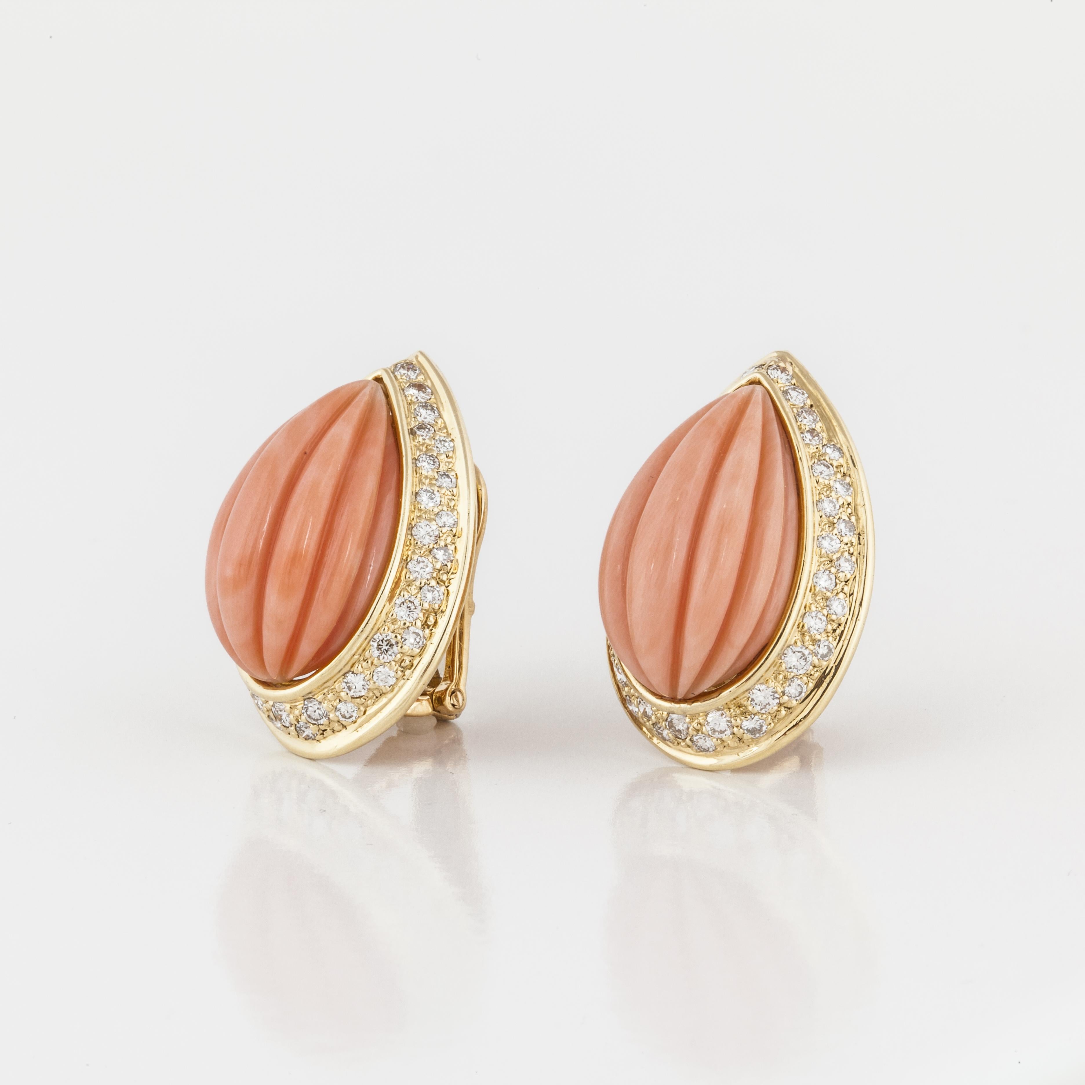 Estate David Webb earrings in 18K yellow gold featuring melon-cut angel skin coral framed with round diamonds that total 1.90 carats.