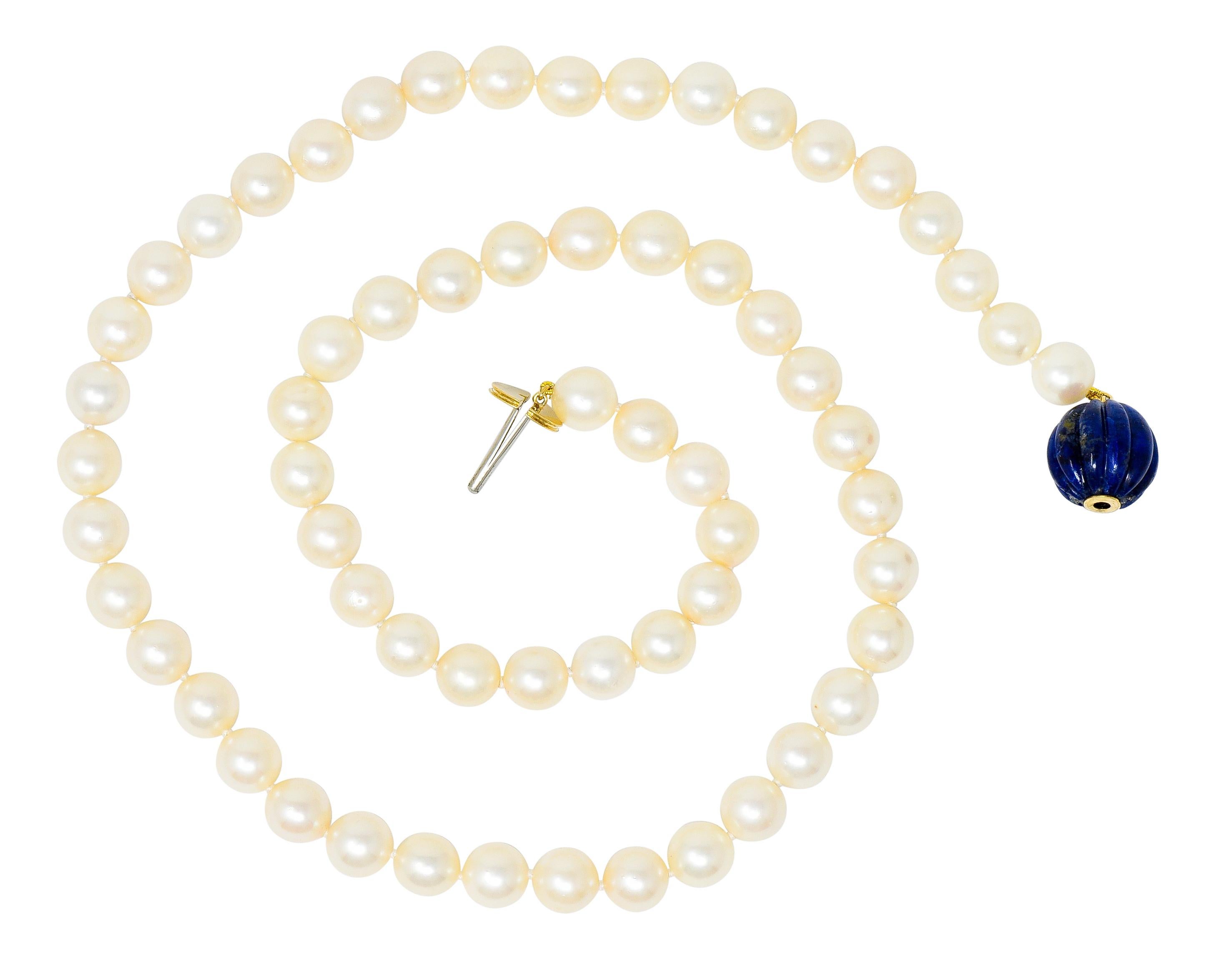 Hand knotted strand necklace comprised of round cultured pearls measuring from 8.5 to 8.8 mm

Incredibly well-matched cream body color with moderate rosè overtones and a very good luster

Terminating as a deeply fluted 14.8 mm lapis bead, opaque and