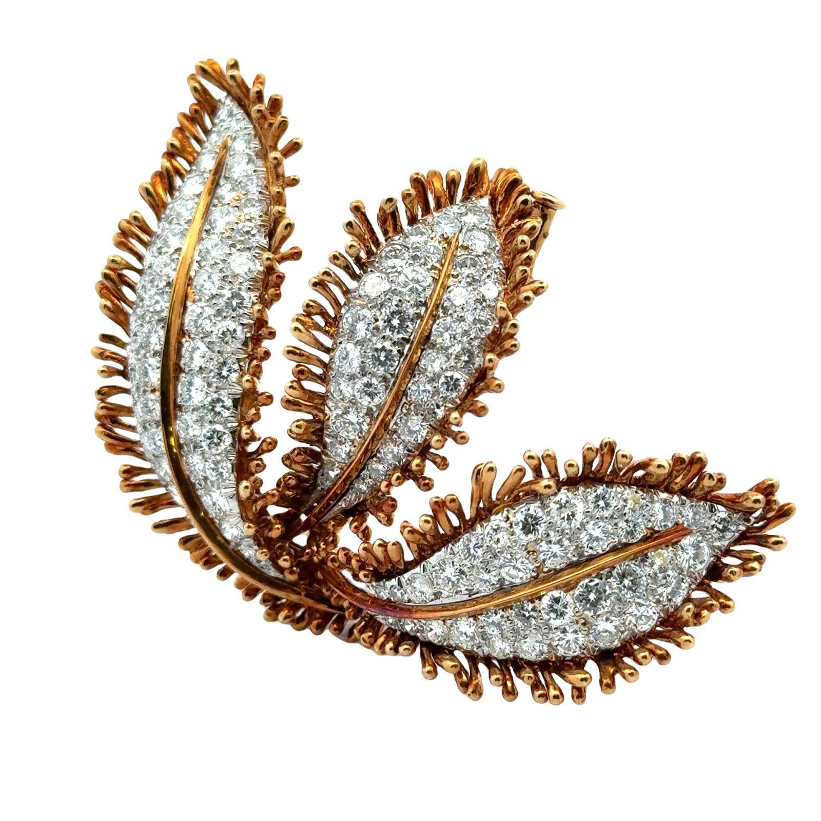 This exquisite vintage leaf brooch by David Webb is crafted from 18-karat yellow gold and platinum, adorned with dazzling diamonds. The diamonds weigh approximately 8.00 carat total weight and are graded F-H color and VS2-SI1 clarity. The intricate
