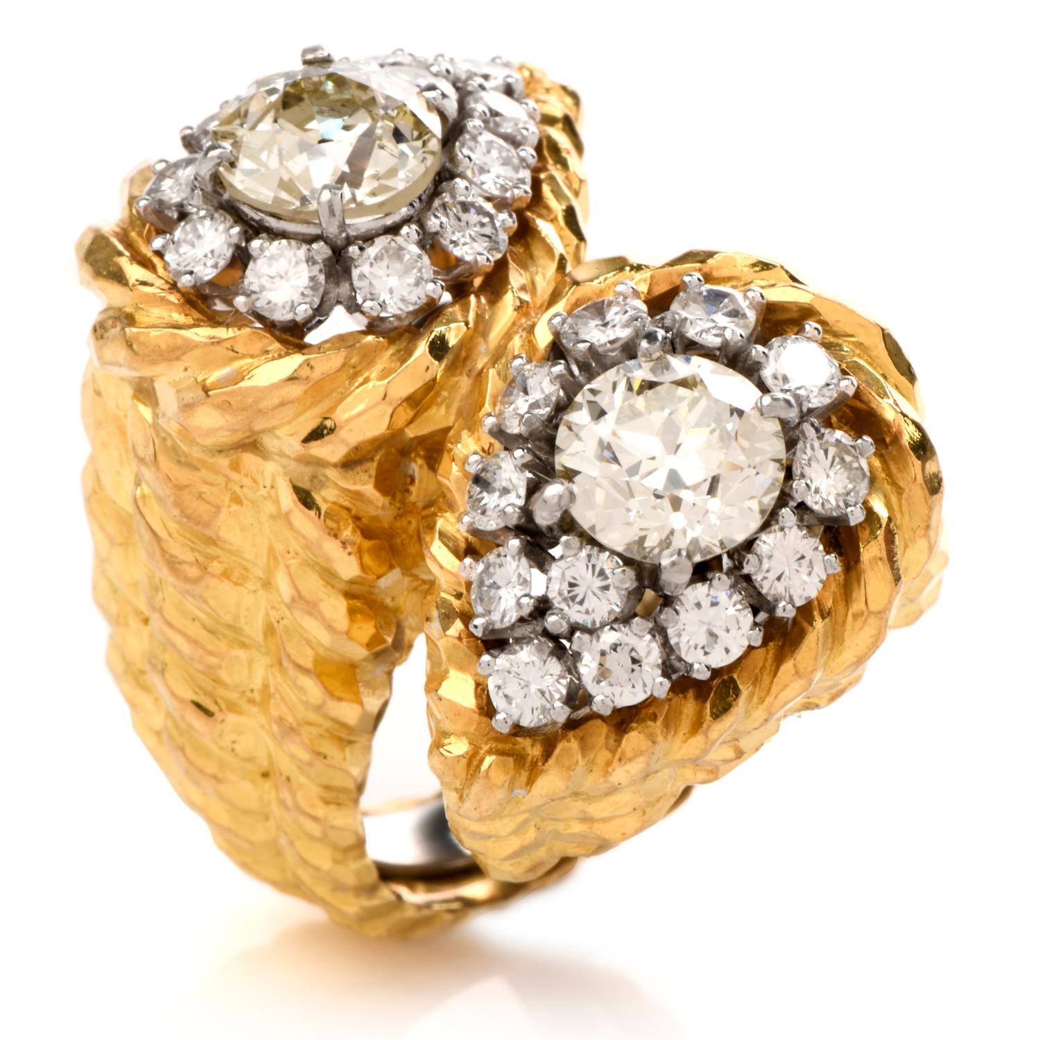 This extravagant designer David Webb diamond cocktail ring is crafted in 18-karat yellow gold and platinum, weighing 27 grams and measuring 28mm x 14mm high. Showcasing a bypass design set with a pair of centered, prong set, round cut diamonds. One