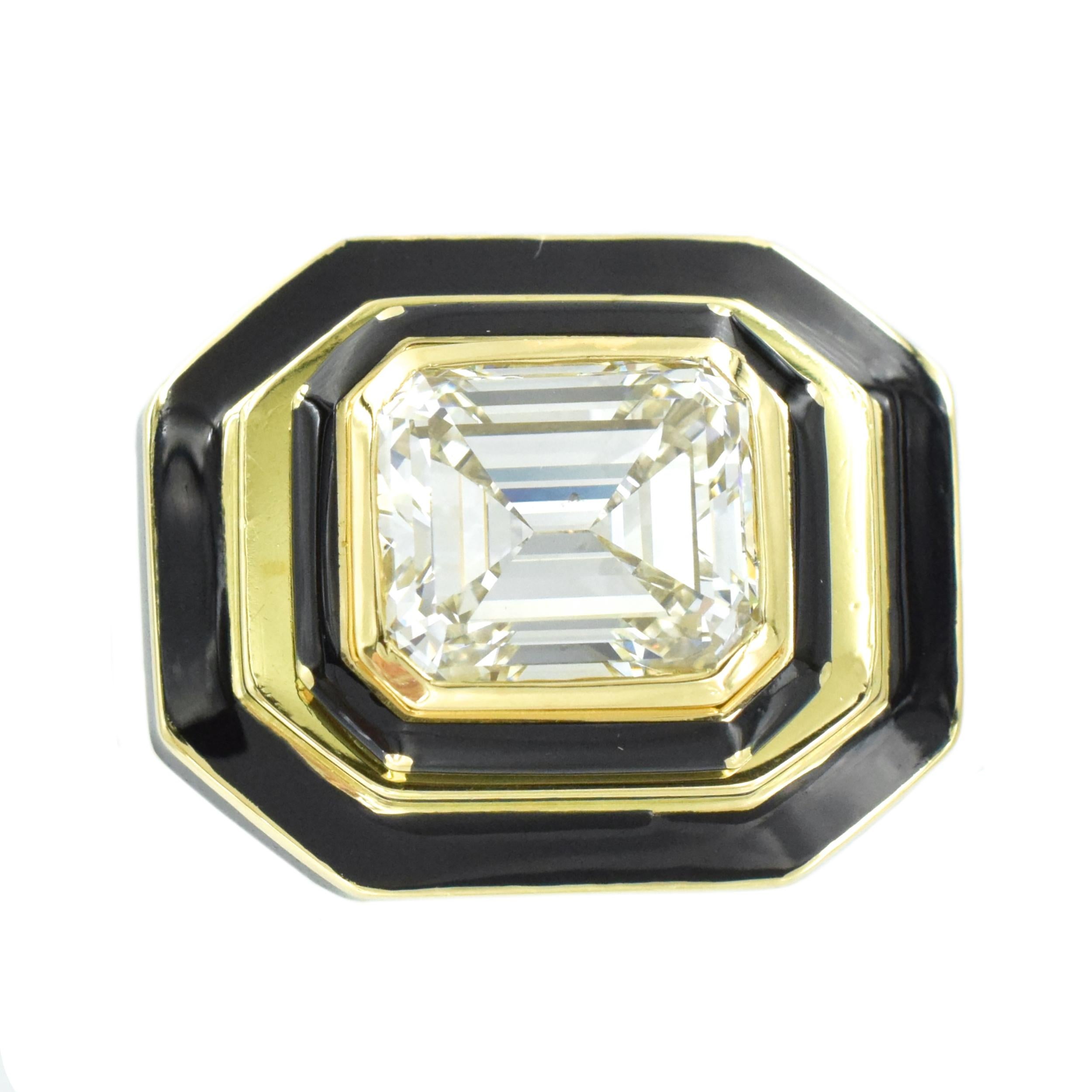 David Webb Diamond And Black Enamel Cocktail Ring In 18k Yellow Gold. Center of this ring is bezel set with 6.00carats emerald cut diamond (Color: J, Clarity:SI1 , GIA#6814489), placed horizontally. Surrounded by halos of 18k yellow gold with black