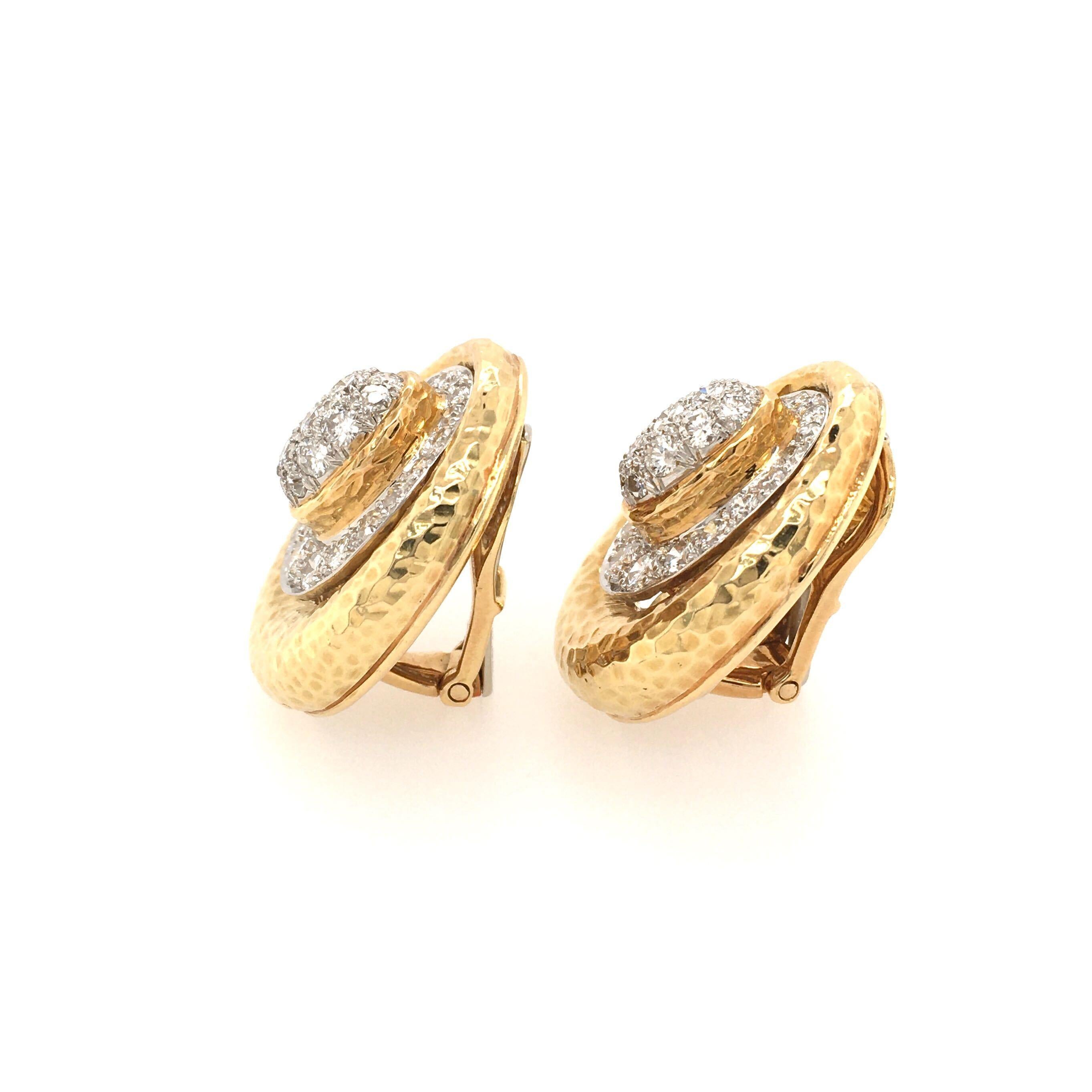 A pair of 18 karat yellow gold and diamond earrings. David Webb. Circa 1970. Of oval hammered design, enhanced by pave set diamonds. Sixty two (62) diamonds weigh approximately 3.25 carats. Length is approximately 1 inch, gross weight is