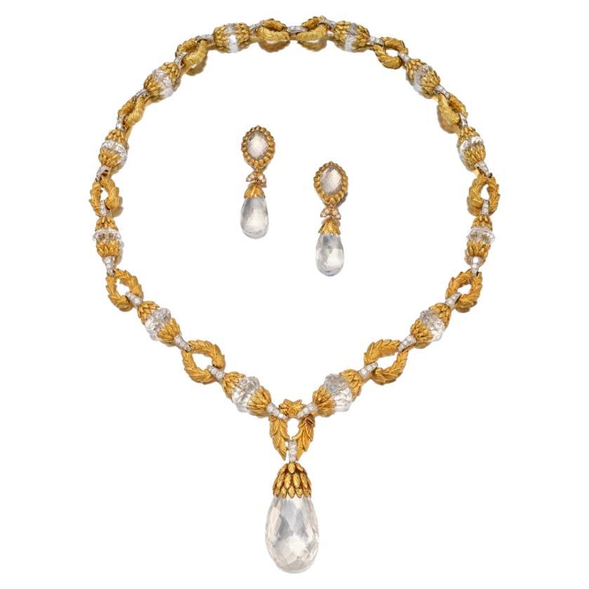 David Webb foliate inspired diamond and rock crystal necklace and earrings suite in 18k yellow gold and platinum. The necklace consists of two different types of links alternating, plain 18k yellow gold and
rock crystal faceted bead with 18k yellow 