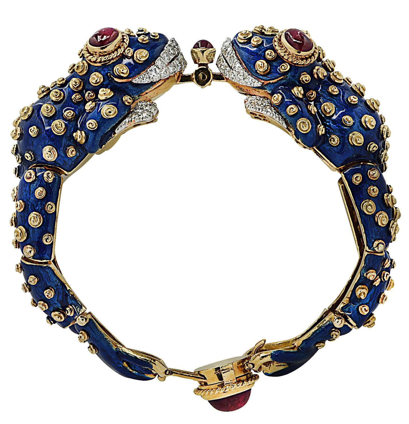 Stunning David Webb diamond, cabochon ruby, and blue enamel bracelet crafted in 18 karat yellow gold and platinum. Featuring 42 round brilliant cut diamonds weighing approximately 0.90 carats total, F color, VS clarity.  Fashioned as an articulated