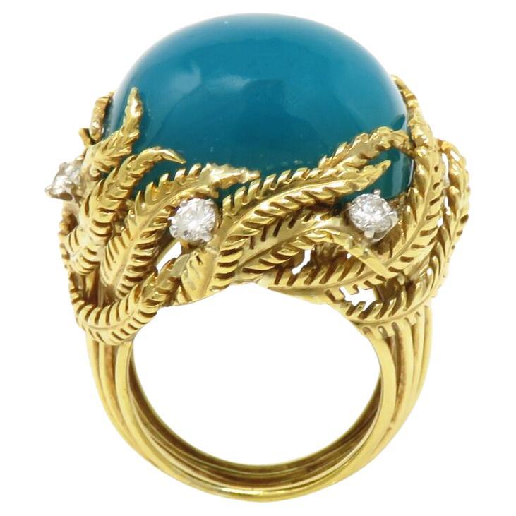 David Webb 18K Yellow Gold and Turquoise ring

 approx 0.65ct of diamonds, most about G-H and VS range

Center stone measures 20.1 x 16.1mm

Marked: Webb 18k 10% IRID Plat

Ring top 28 x 25mm. Ring size 6.25 (Sizable)

Total Weight: 23.9 grams
.