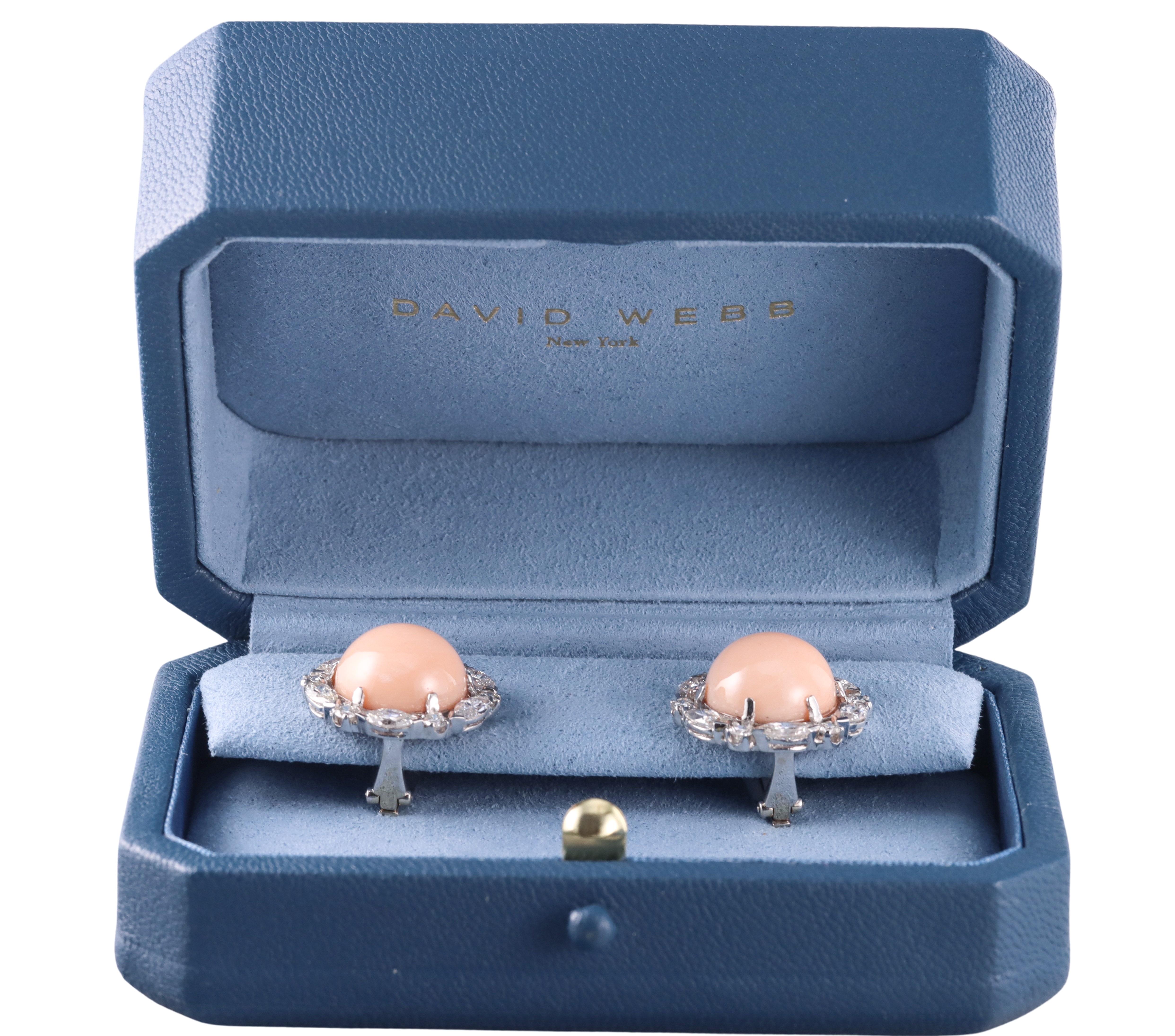 Pair of exquisite and classic button earrings, crafted by David Webb in 18k gold and platinum. The earrings are set with center 14.5mm angel skin corals, surrounded with alternating marquise and round brilliant diamonds - total approximately 3.50cts