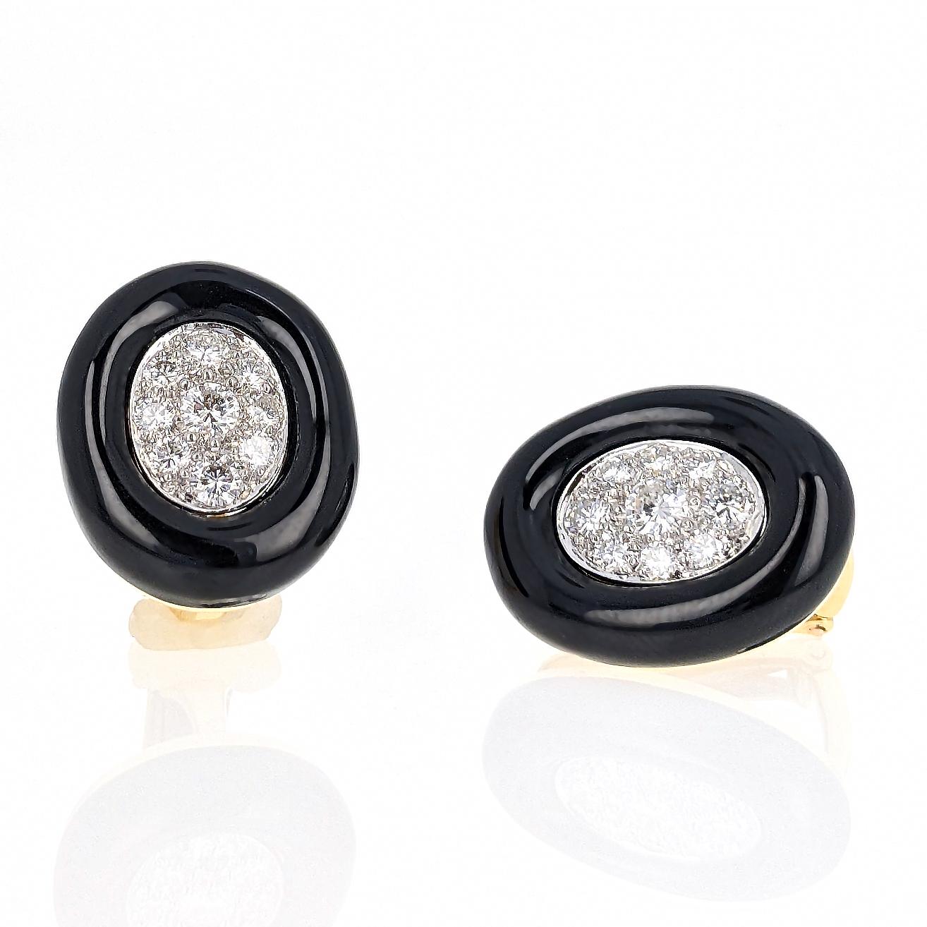 These oval-shaped clip earrings by David Webb feature 18 round brilliant-cut diamonds weighing approximately 1.3 carats total and are surrounded by black enamel. Mounted in 18 karat yellow gold and platinum. Signed Webb and marked 18K PLAT.

These