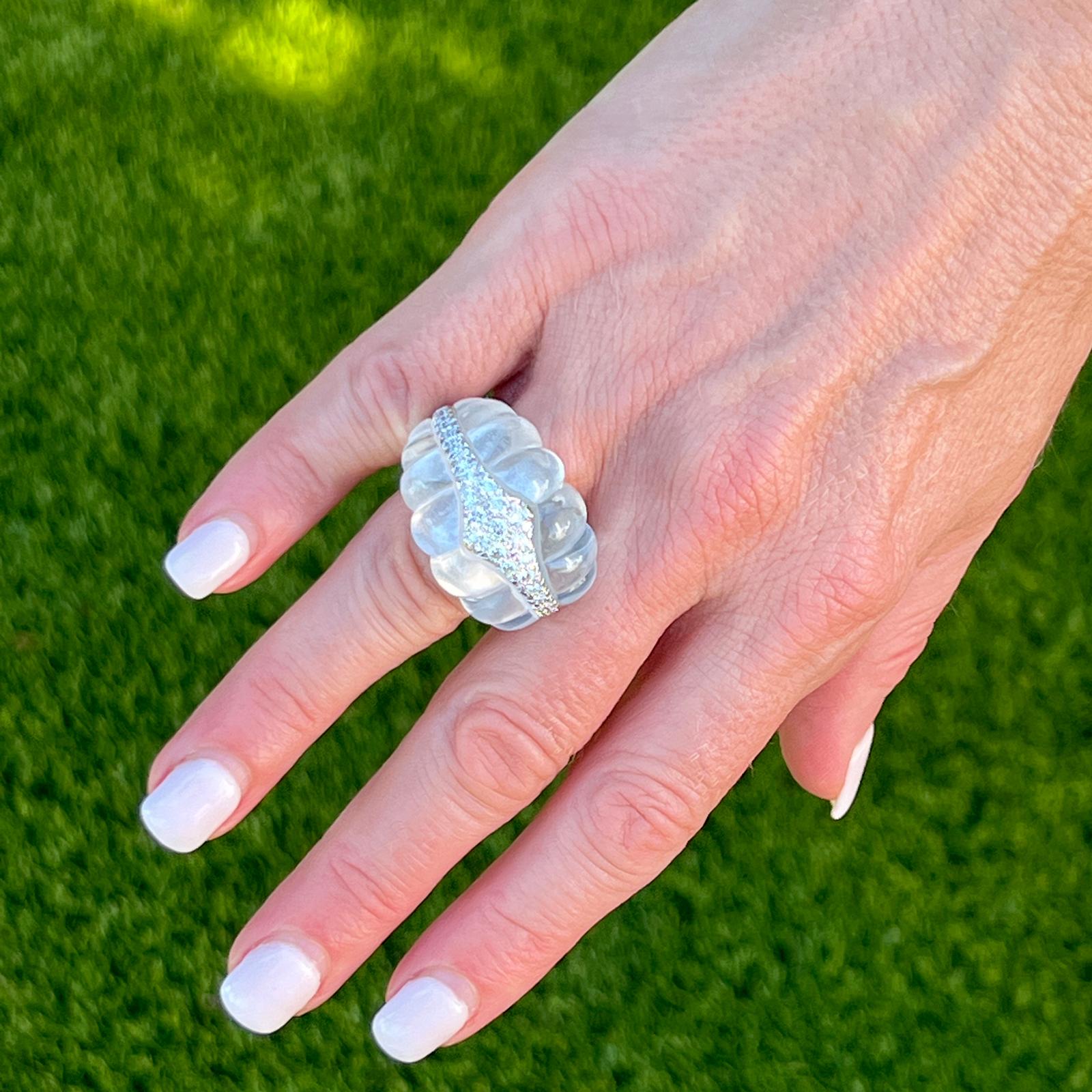 Fabulous David Webb diamond and rock crystal cocktail ring handcrafted in 18 karat white gold and platinum. The dome shape estate ring features carved rock crystal gemstone and round brilliant cut diamonds weighing approximately 1.20 carat total