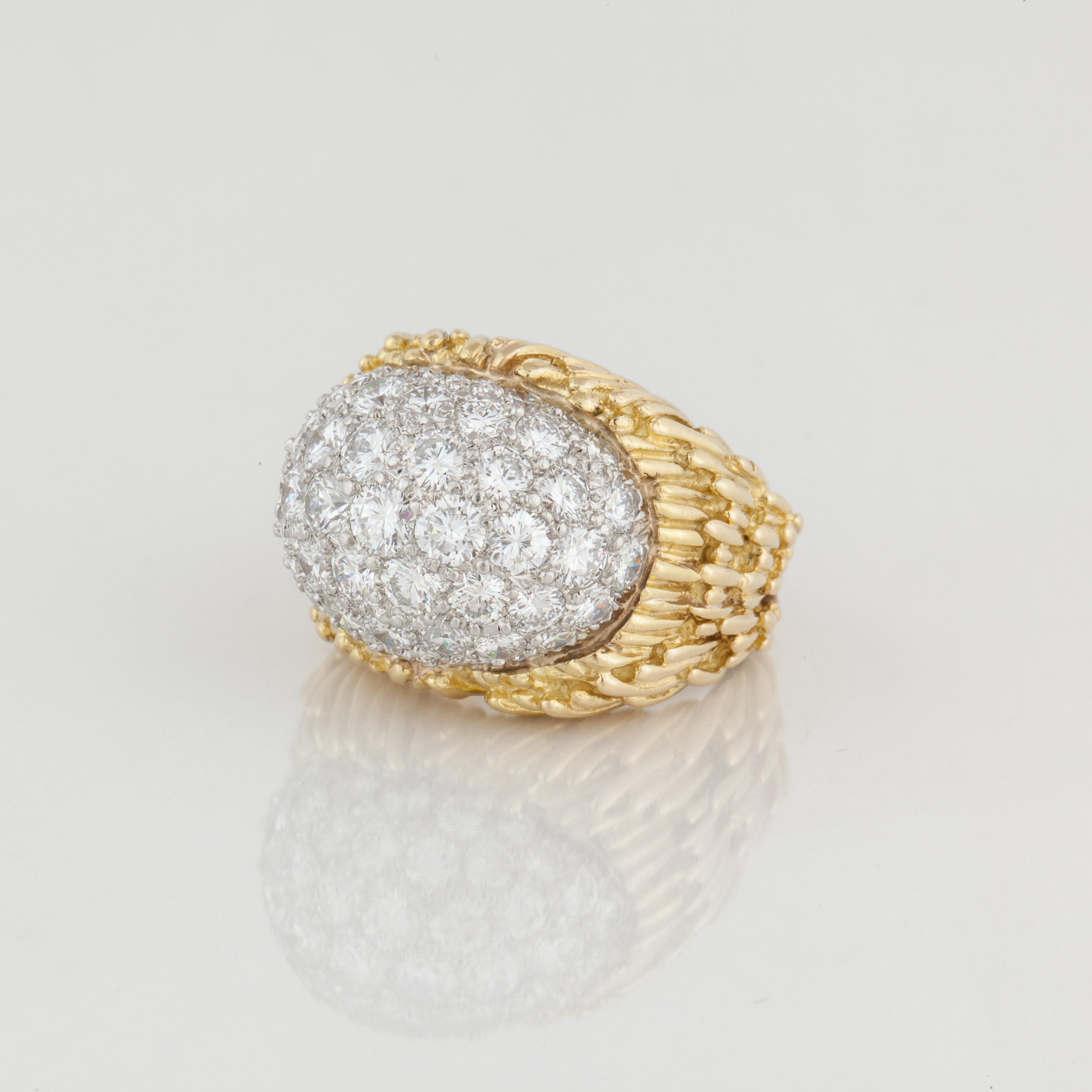 Vintage 18K yellow gold dome ring by David Webb.  Textured gold finish featuring 50 round brilliant-cut diamonds that total 5.50 carats; G-H color and VVS-VS clarity.  The diamonds are set in platinum.  The ring is a size 7 with a butterfly insert. 
