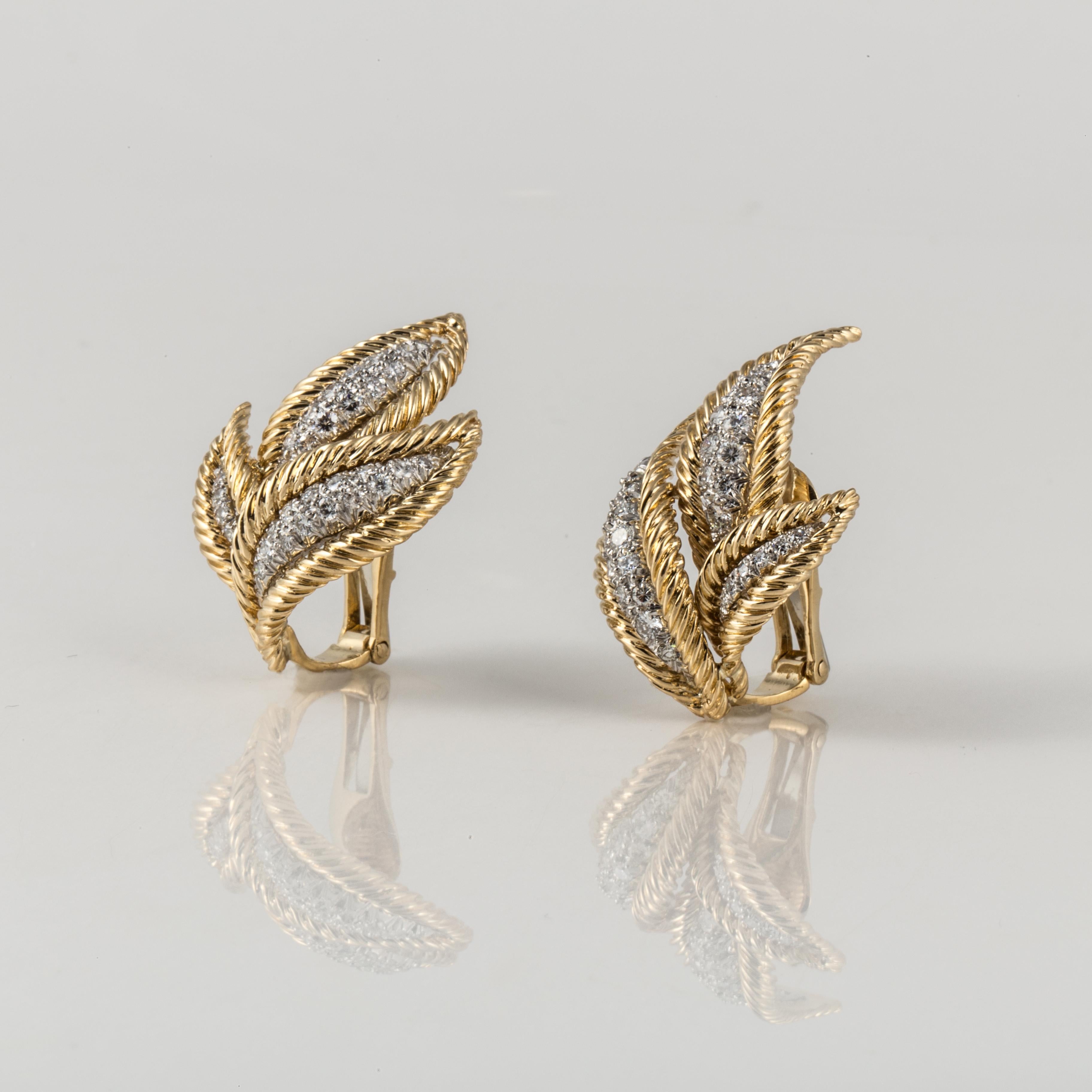 David Webb earrings composed of 18K yellow gold and platinum with diamonds.  Leaf design set with seventy (70) round diamonds that total 2.10 carats; G-H color and VVS2-VS1 clarity.  Measure 1 1/2 inches long and 1 inch wide.  Clip style.