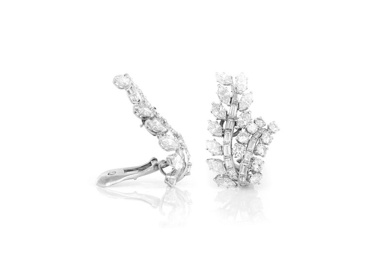 David Webb clip-on earrings finely crafted in platinum and 14k white gold with diamonds. 