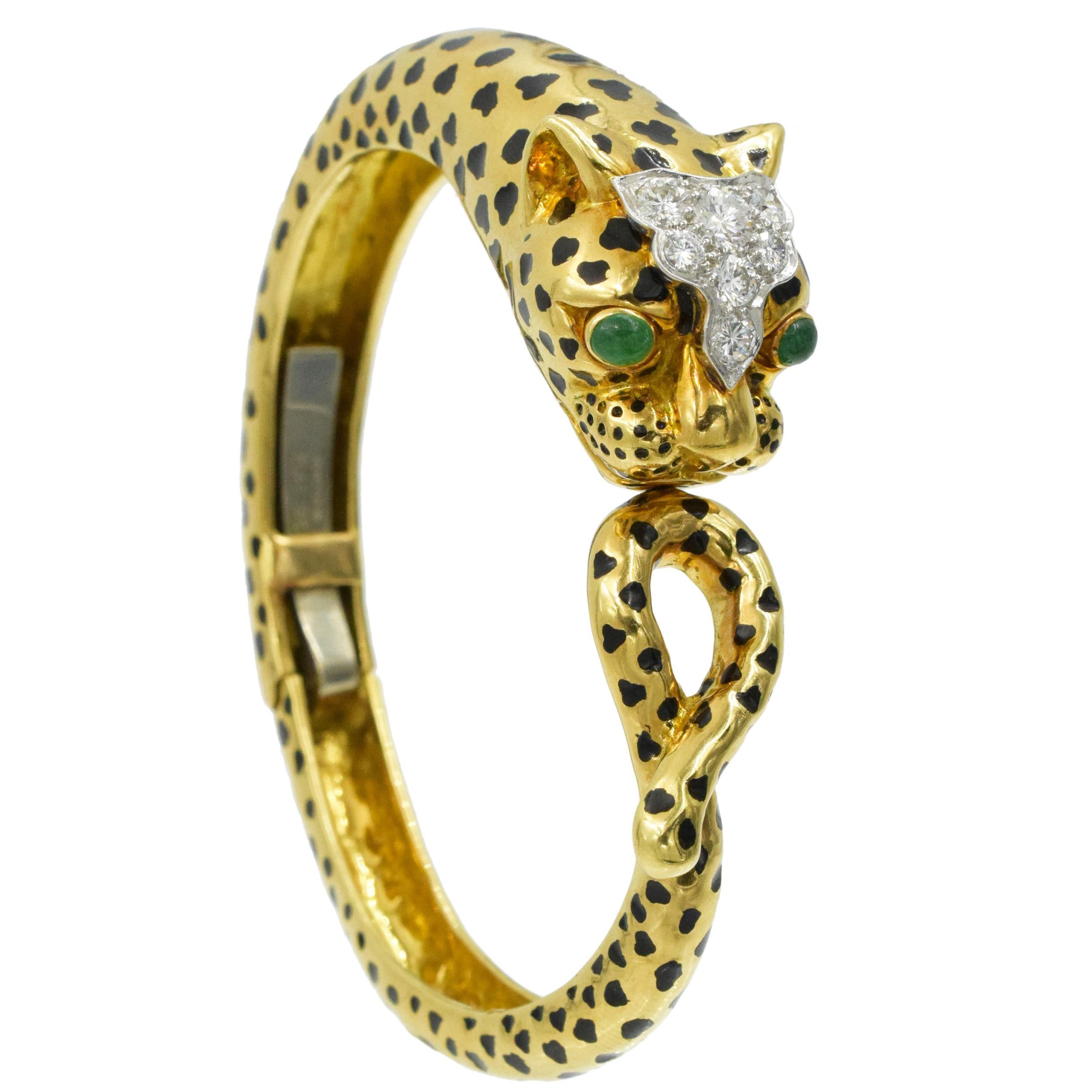 David Webb Diamond, emerald and black enamel
Leopard bracelet in 18k yellow gold and platinum. This  bangle features 18K  yellow gold leopard head with bezel set cabochon emerald  eyes and top of the head in platinum, encrusted with 7 round