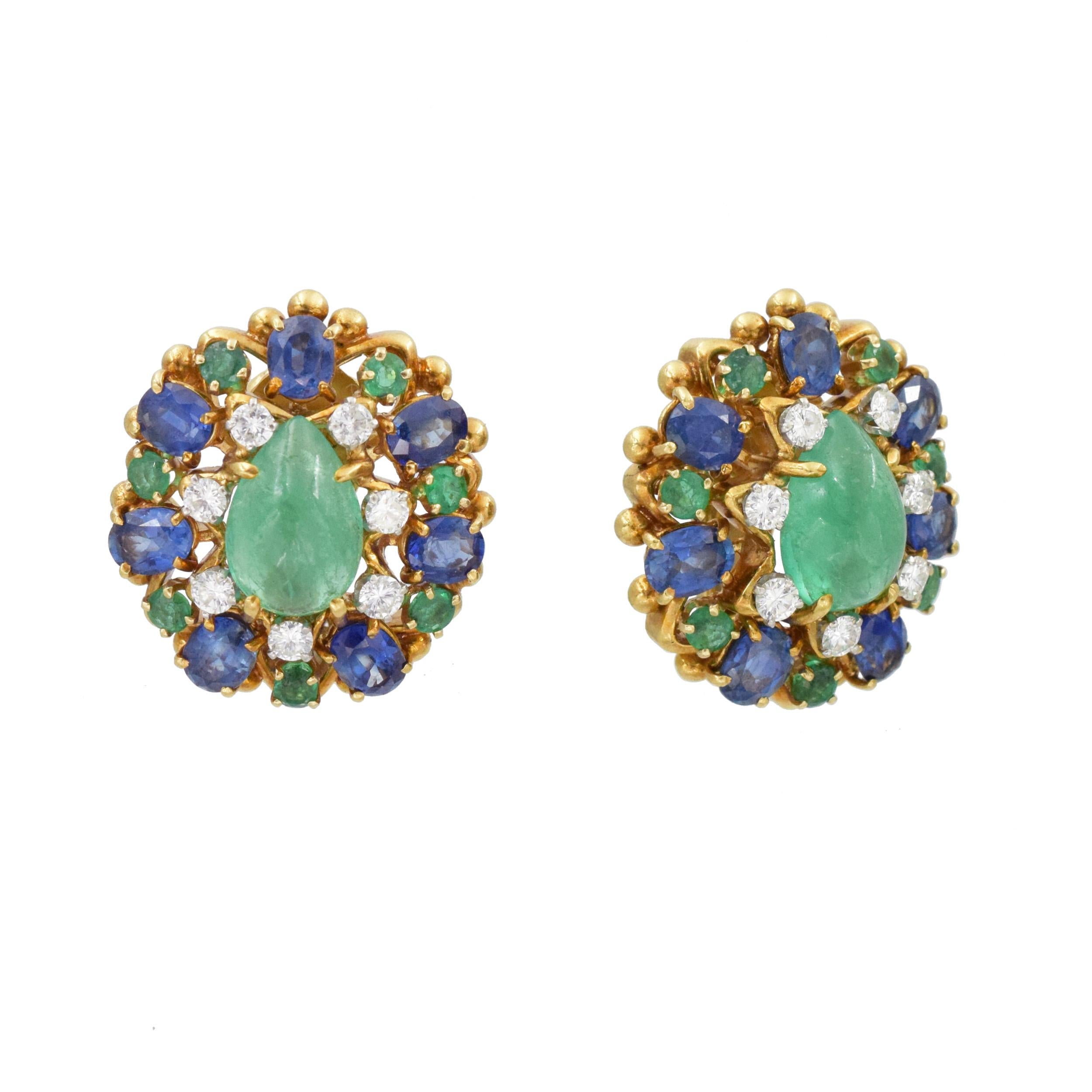 David Webb Diamond, Emerald, and Sapphire Cabochon Earrings.
Set with 2 Pear Shaped Cabochon Emeralds approximately 6.0 -7.0ct total weight. These earrings also have 14 round brilliant diamonds that weigh approximately 0.65ct. Color: F/G. Clarity: