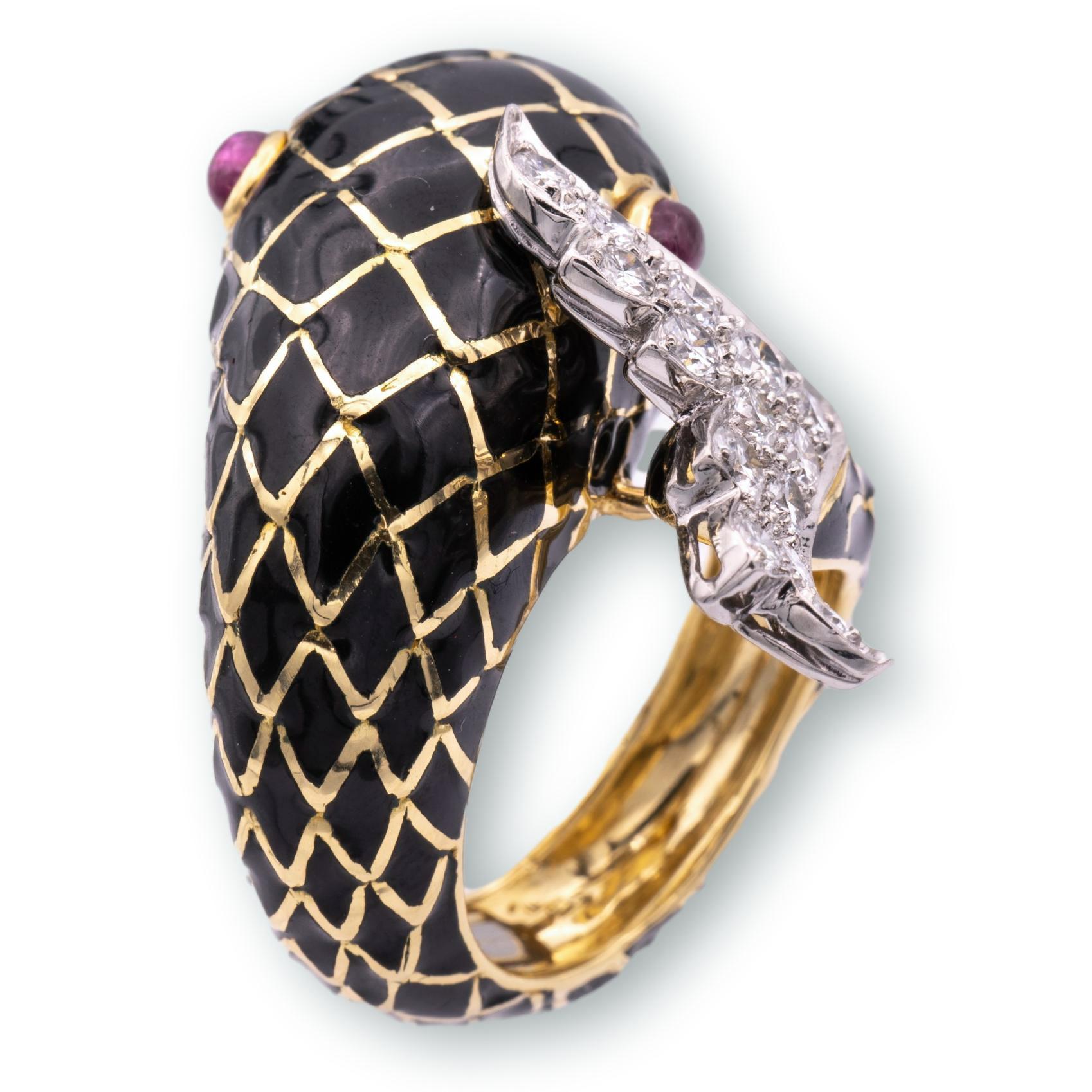 Estate David Webb bypass ring from the iconic animal collection finely crafted in 18 karat yellow gold and platinum in a coiling fish motif featuring a black enamel lattice pattern and cabochon ruby eyes, fine quality round brilliant cut diamonds on