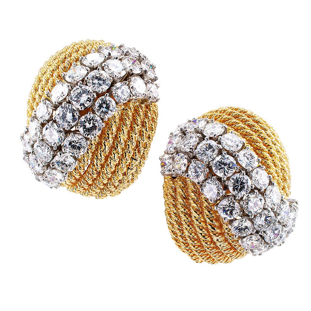 David Webb diamond and gold clip-on earrings circa 1970. The matching domed designs are fashioned from multiple strands of corded gold traversed by s-shaped triple courses of round brilliant-cut diamonds totaling approximately 7.00 carats,