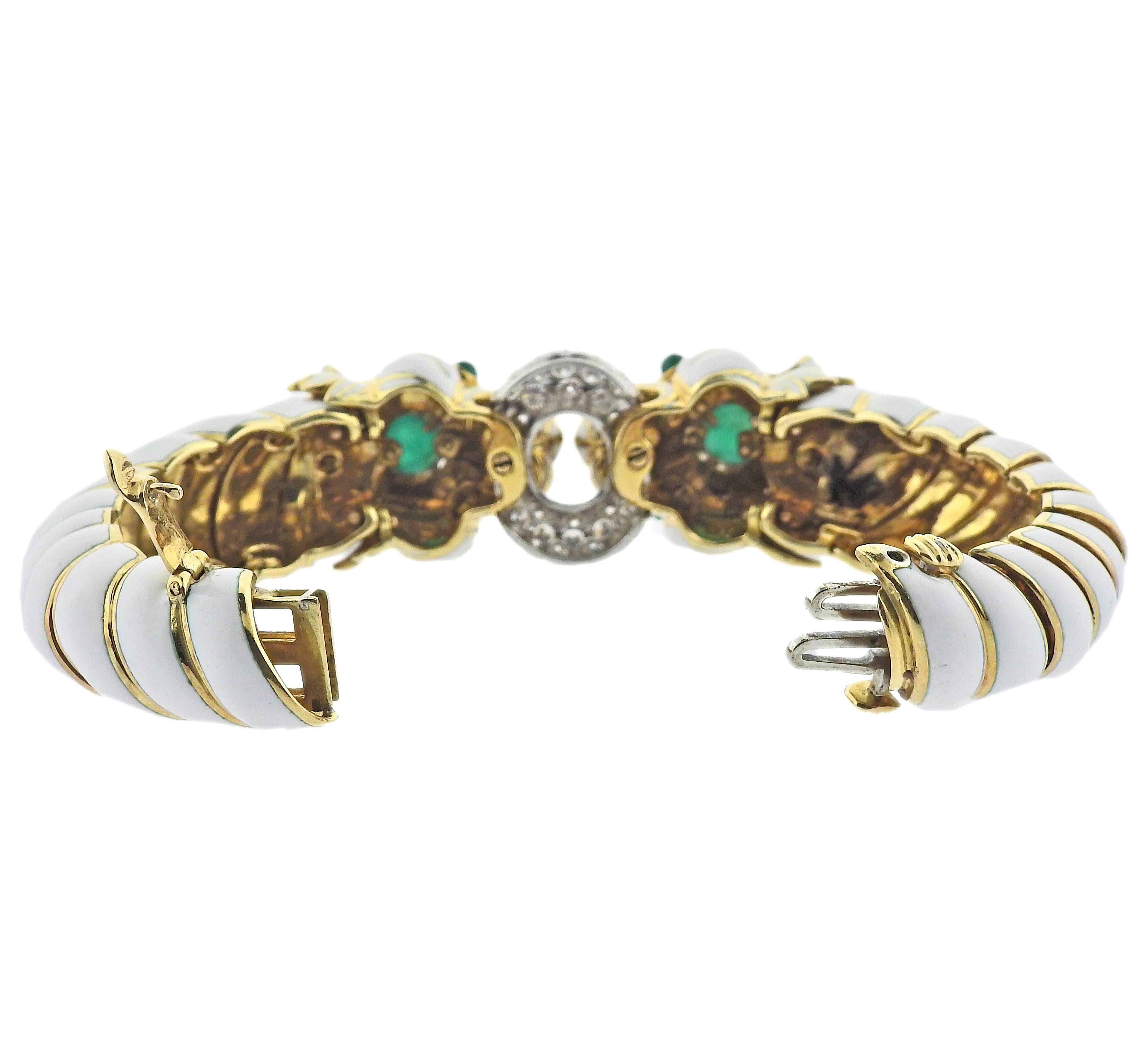 Impressive 18k gold, platinum and enamel twin lion bracelet by David Webb, set with cabochon emeralds and approx. 2.00ctw in VS/H diamonds. Bracelet will fit approx. 6.5