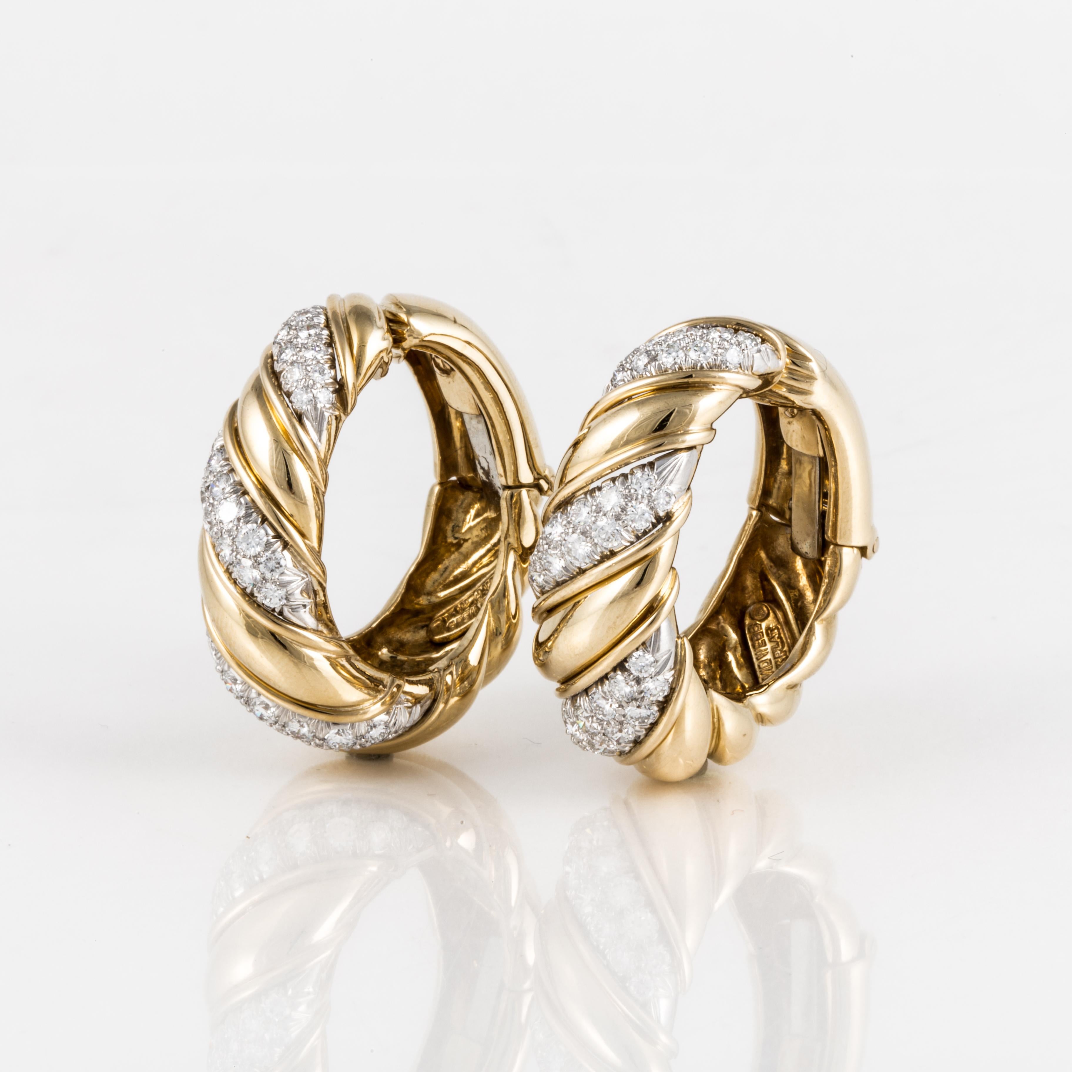 David Webb hoop earrings in 18K yellow gold and platinum with diamonds.  There are seventy-four (74) round diamonds that cross the earrings diagonally.  They total 3.10 carats; G-H color and VVS-VS clarity.  Measure 1 1/4 inches long and 1/2 inches