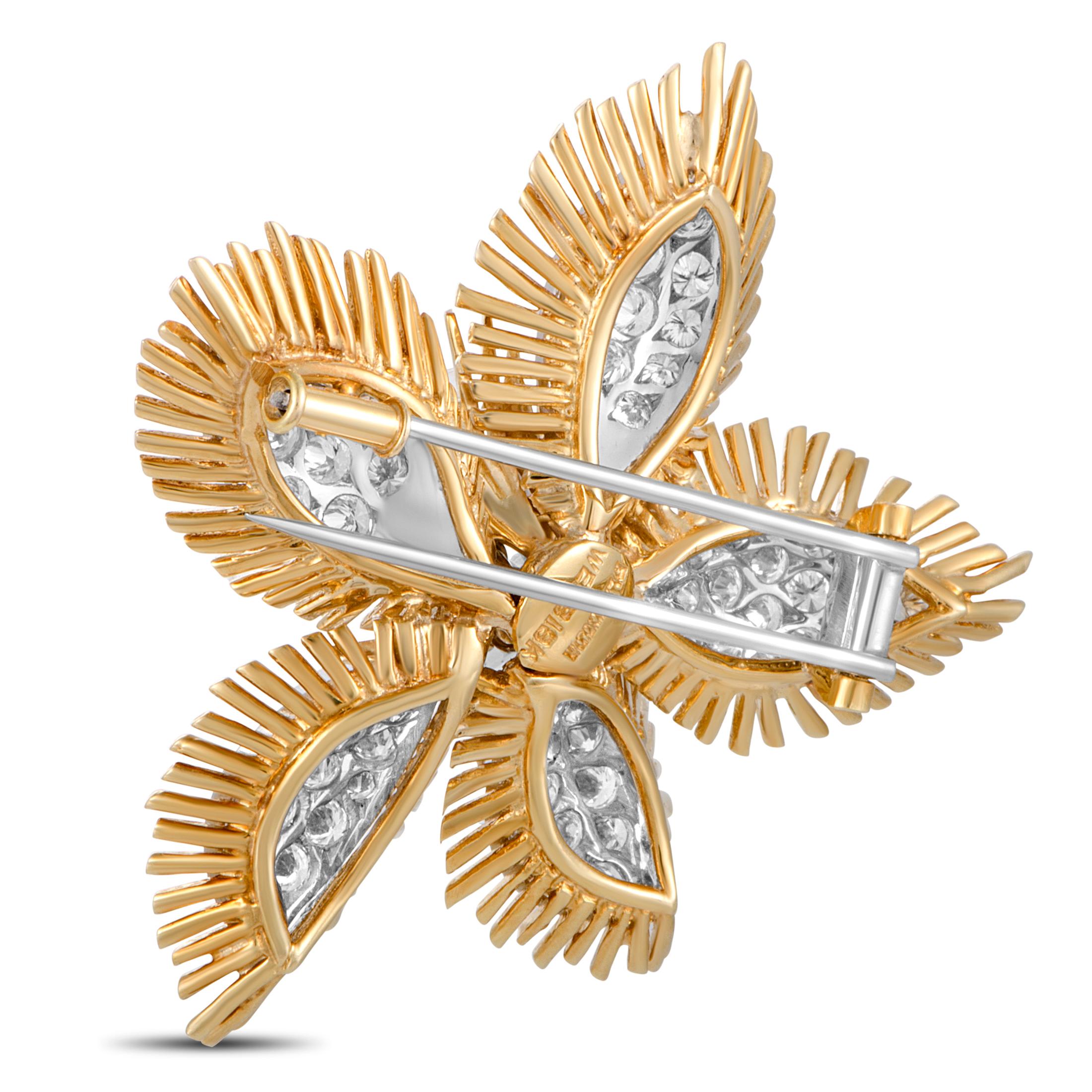This David Webb brooch is made of 18K yellow gold and platinum and set with a total of 8.00 carats of diamonds that boast grade F color and VS1 clarity. The brooch weighs 31.2 grams and measures 2.00” in length and 2.00” in width.