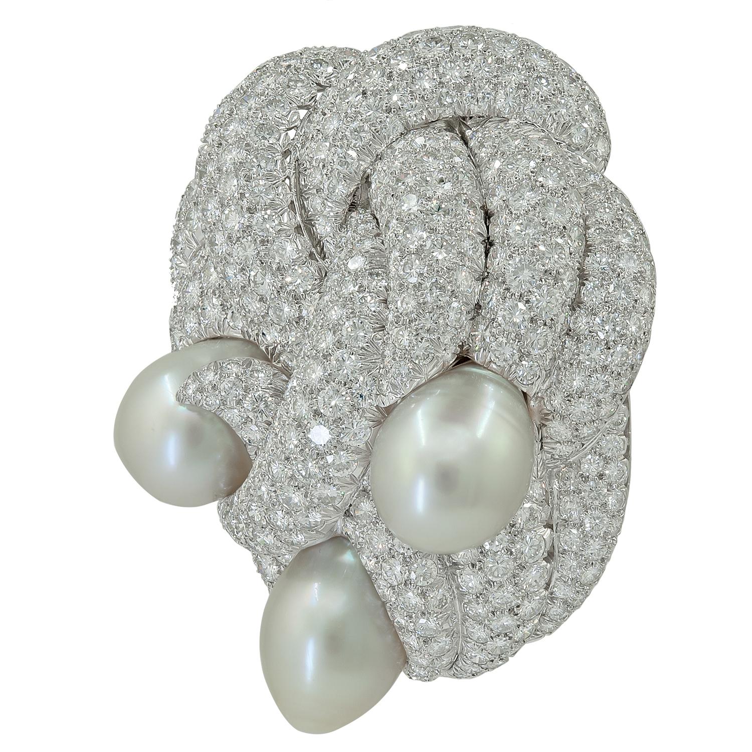 DAVID WEBB Diamond, Pearl Brooch
Platinum clip brooch, set with round brilliant-cut diamonds, and three cultured pearls.
Pearl dimensions approx. – 24.8 by 15.1 by 15.1 mm
22.1 by 15.4 by 15.4 mm
21.1 by 15.9 by 15.5 mm
Total diamond weight approx.