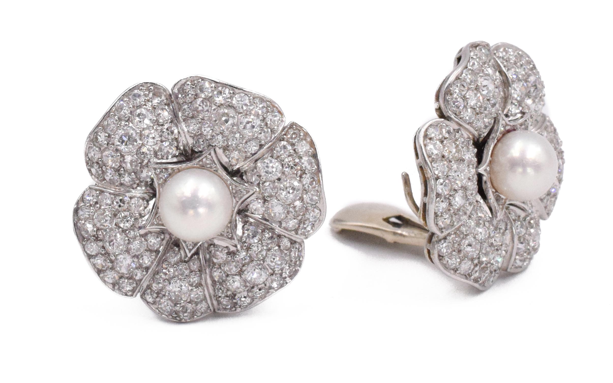  Diamond and Cultured Pearl Earrings This pair of earrings has round diamonds with a tota carat weight of approximately 6ct around 2 center pearls measuring about 7.5mm each, all set in platinum.
 