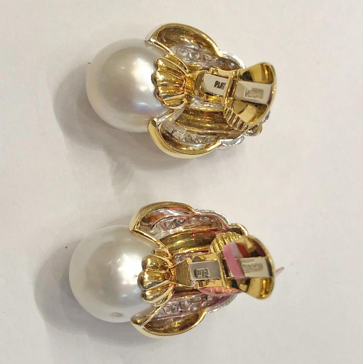 Stunning 1980s fluted 18K gold surmounts, with bands of circular-cut diamonds set in platinum, the bottom with a large cultured pearl. 
The perfect earring that covers and says it all.
Circa 1980s. Signed David Webb