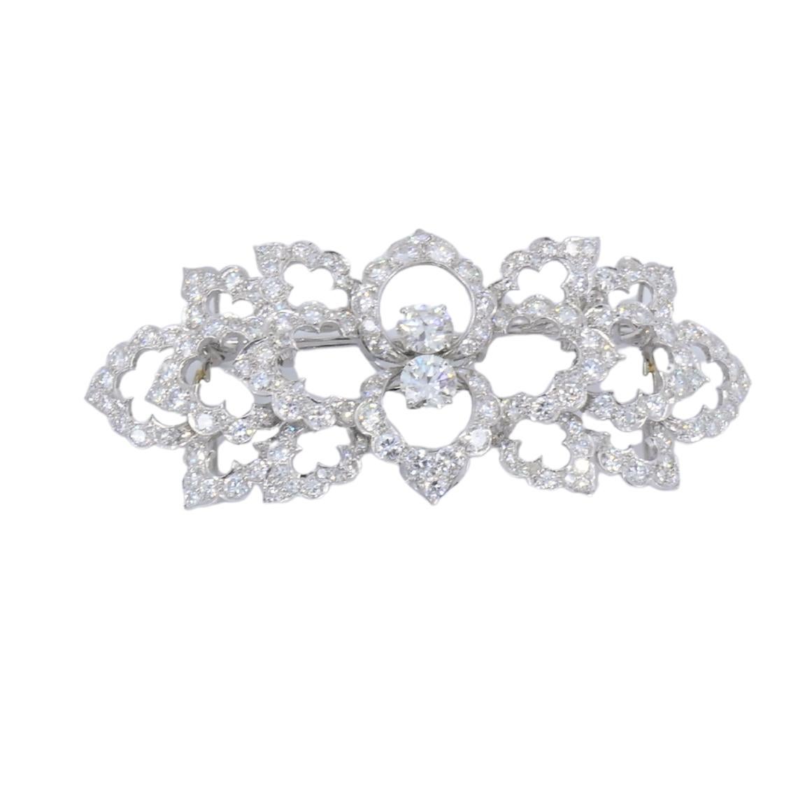 This vintage David Webb brooch is a refined example of the designer’s work in platinum and diamonds. The piece features an openwork layout built around botanical motifs, giving the brooch an airy structure.  The design centers on a stylized flower,