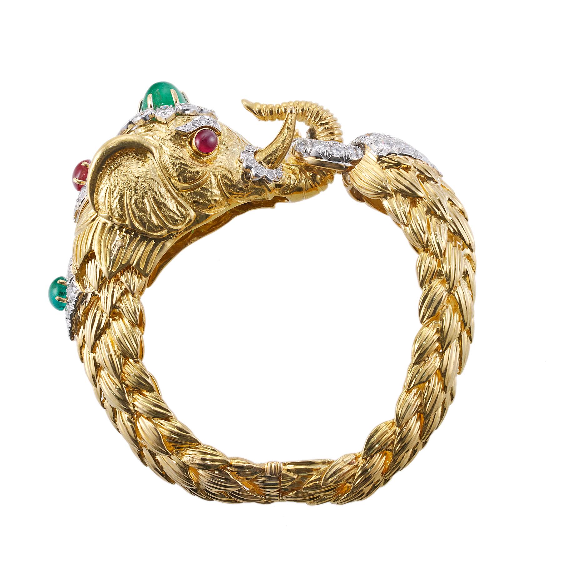 Exquisite David Webb elephant bracelet, set in 18K gold and platinum, with approx. 5.00 ctw in VS-SI/H diamonds, cabochon ruby and cabochon emeralds. Bracelet will fit an approx. 7
