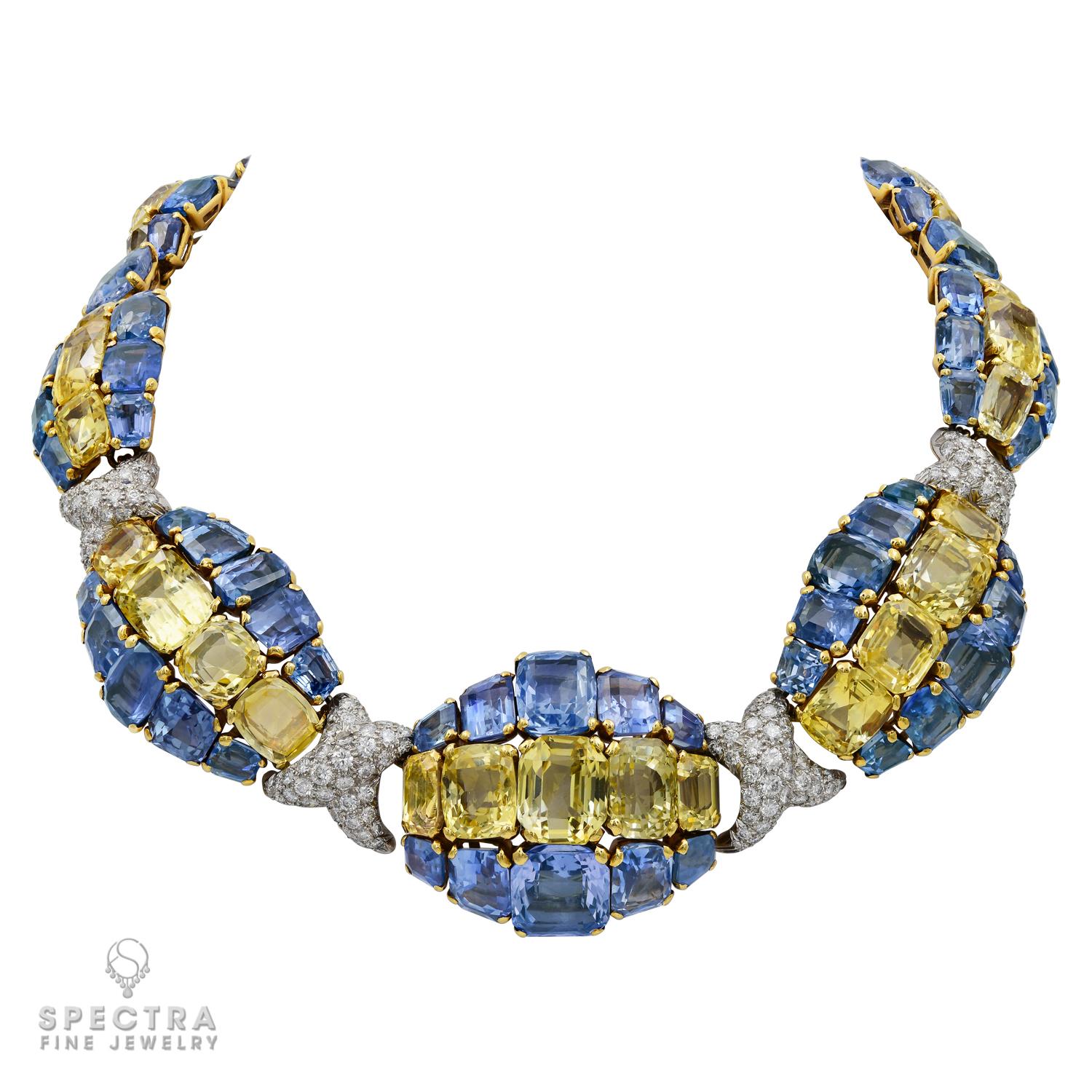 This Signed David Webb Diamond Yellow & Blue Sapphire Gold Necklace, made in the middle of the 20th century, features a dazzling array of yellow and blue sapphires arranged in three stripes that flow around the neck in a spectacularly unusual