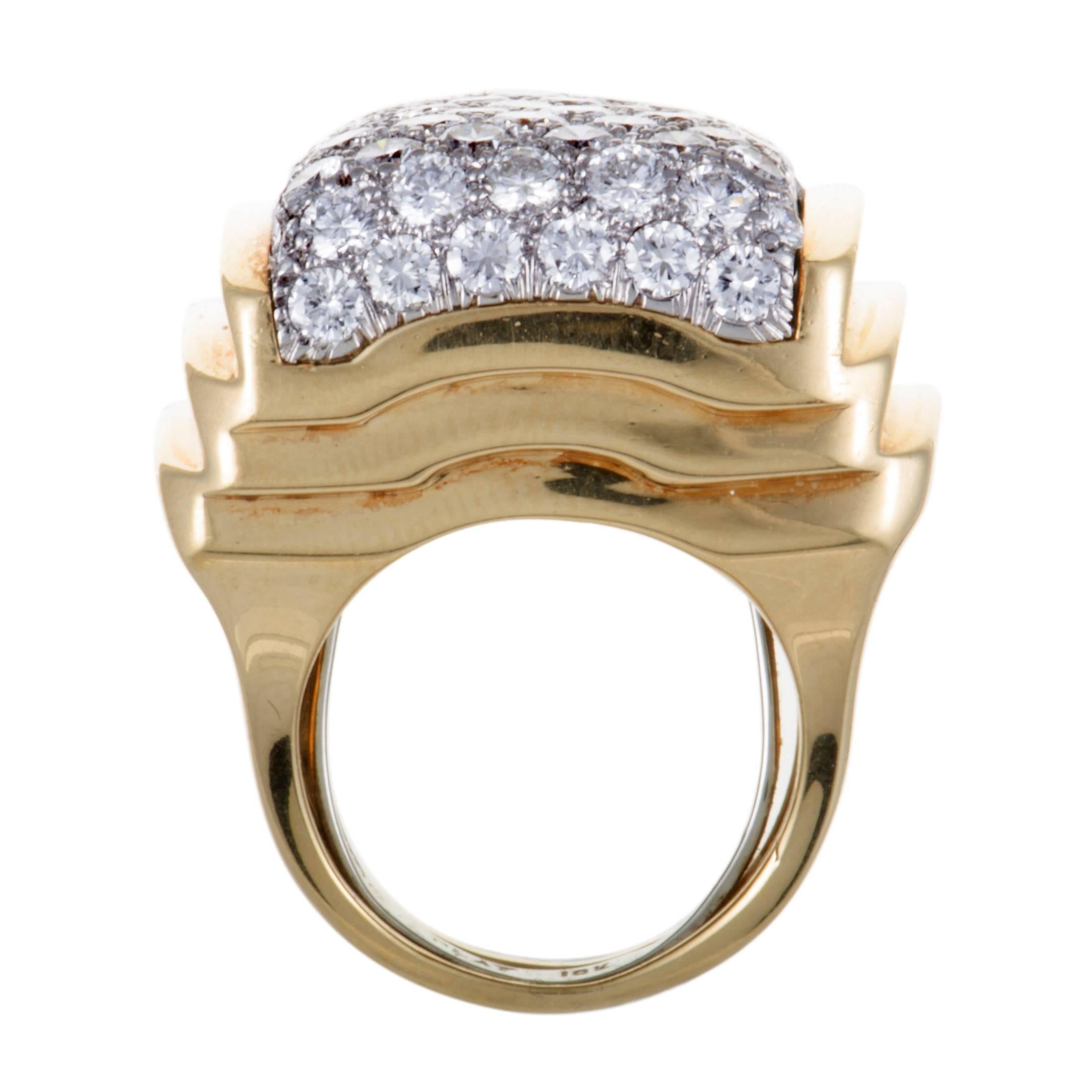 The lustrous brilliance of diamonds that are set against the elegantly gleaming platinum backdrop is beautifully brought out in this majestic ring by the enchanting radiance of 18K yellow gold. The ring is a David Webb design and it boasts a total