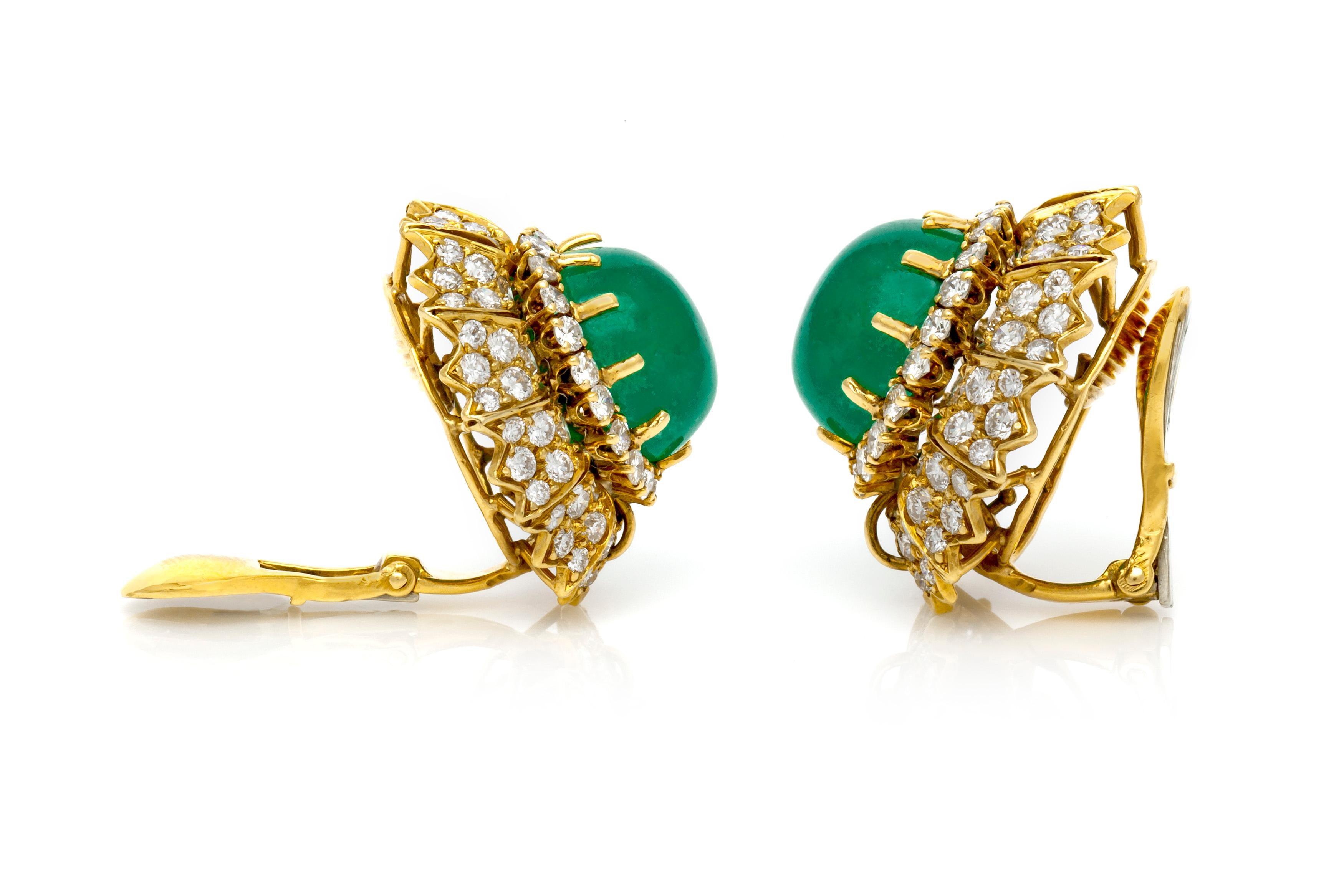 Finely crafted in 18k yellow gold with two Cabochon center Emeralds weighing approximately a total of 18.00 carats.
The earrings feature round brilliant cut diamonds weighing approximately a total of 8.00 carats.
Clip-ons
Signed by David Webb.
Circa