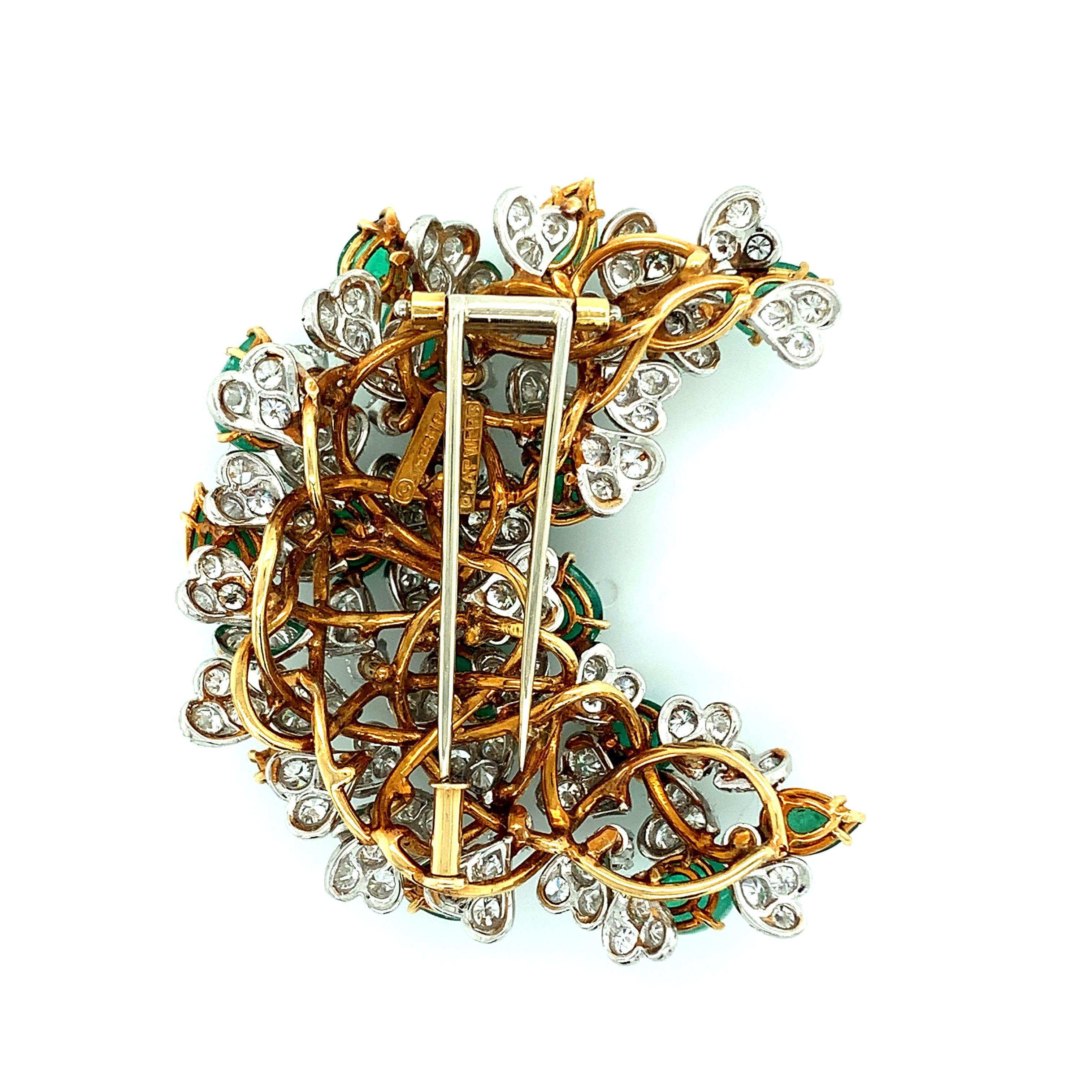 David Webb 18 karat yellow gold and platinum brooch featuring emeralds and diamonds. The emeralds weigh approximately 10 carats and the diamonds weigh approximately 6 carats. Marked: Webb 18K / Plat Webb. Total weight: 41.9 grams. Width: 2 inches.