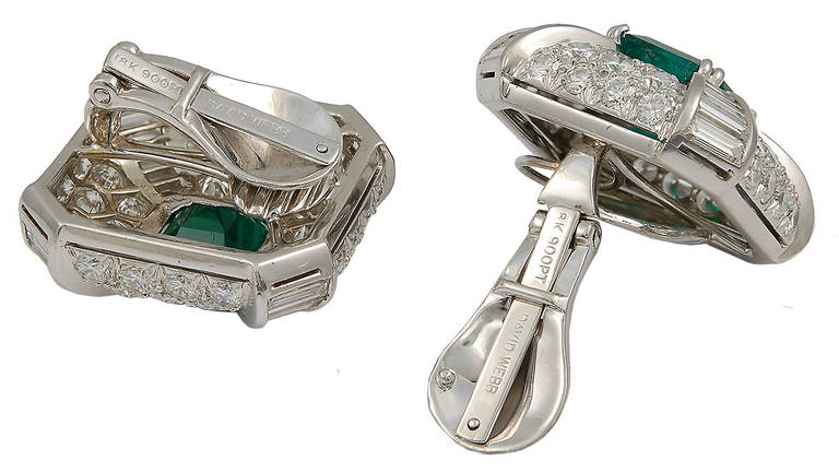 A pair of 1980's emerald and diamond earclips by David Webb; each centrally set with a square vivid green Columbian emerald, with four rows of graduated baguette diamond columns, in a pave-set diamond mounting.

The earclips are mounted in platinum