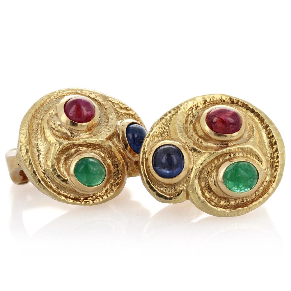 A pair of estate 18k yellow gold earrings sculpted with texture to an organic form and bezel-set with cabochon rubies, emeralds and sapphires. Signed Webb for David Webb. They were originally just clip-ons, but a previous owner had posts added. 

A