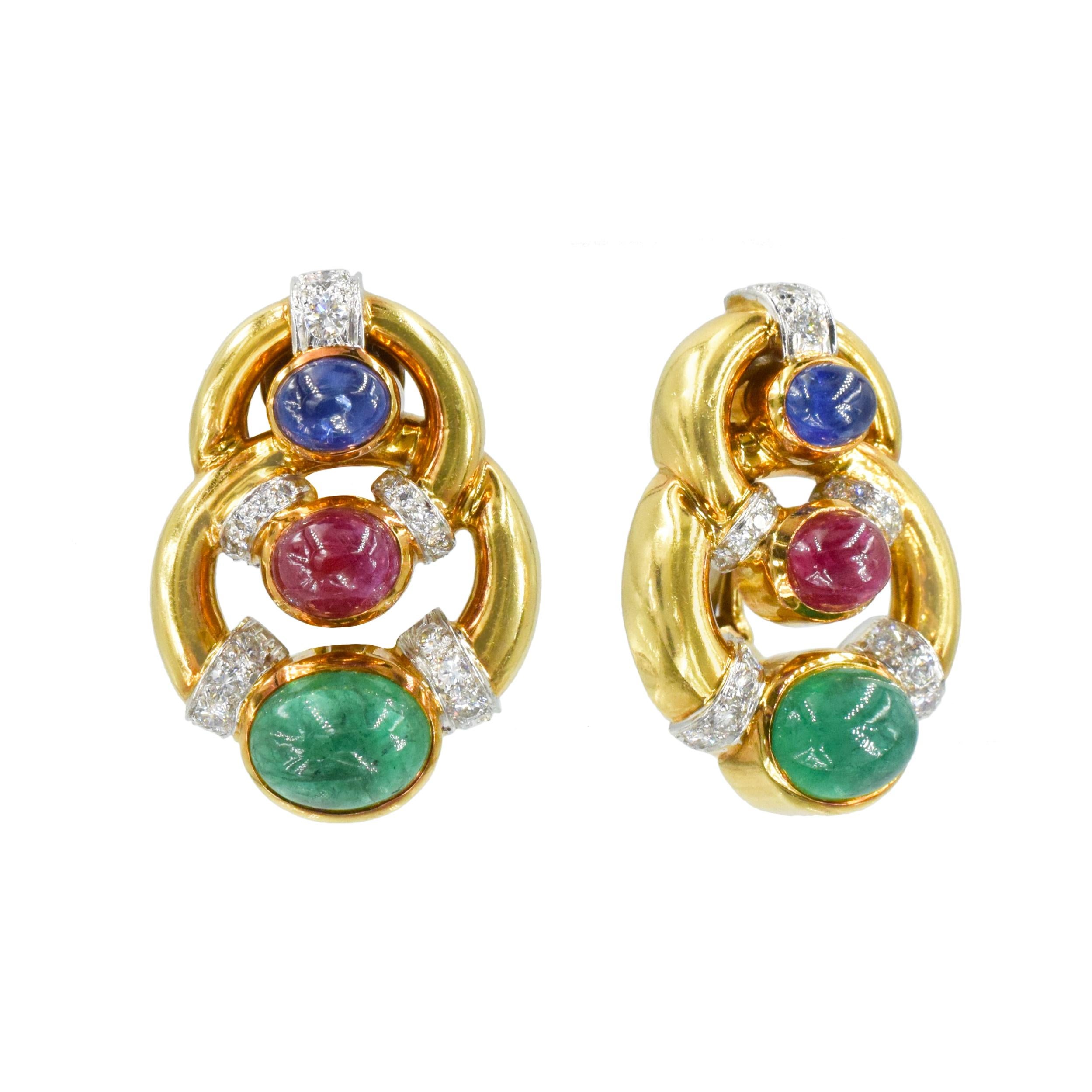 David Webb Emerald, Ruby, Sapphire And Diamond Ear Clip Earrings In 18k Yellow
Gold And Platinum.  Each earring designed as two overlapped circles, one smaller and one larger. Each bezel set with oval cabochon cut emerald, ruby and sapphire,