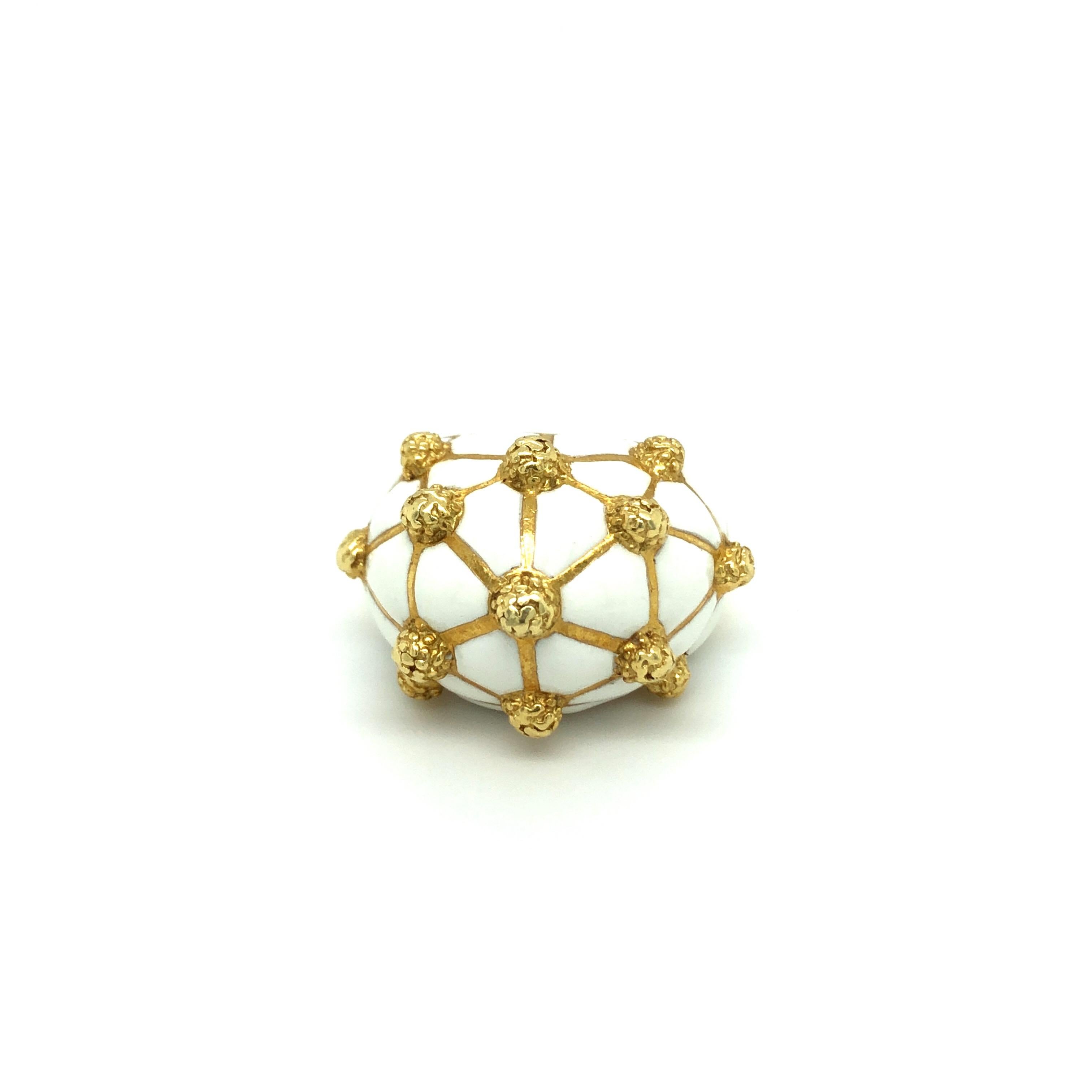 David Webb enamel 18 karat gold geodesic dome ring from the 57th Street collection.
This fabulous cocktail ring is crafted in 18 karat yellow gold and emblazoned with white enamel. The surface of the dome is scattered with raised structured gold