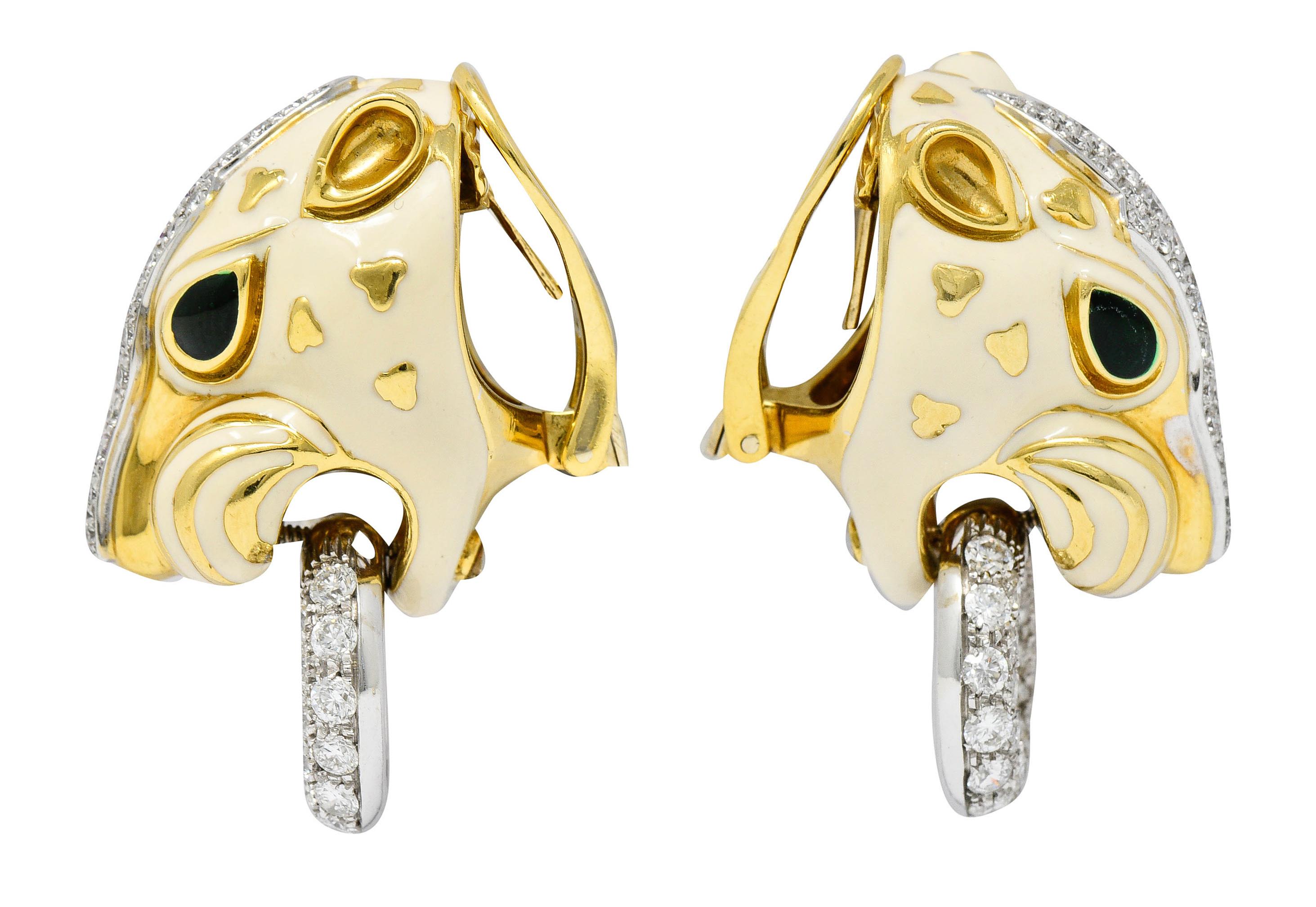 Earrings are designed as stylized lion heads glossed with opaque and cream colored enamel

Accented by high polished details and dark green enamel eyes

With a pavè diamond snout and a white gold pavè diamond ring articulated at the lion's