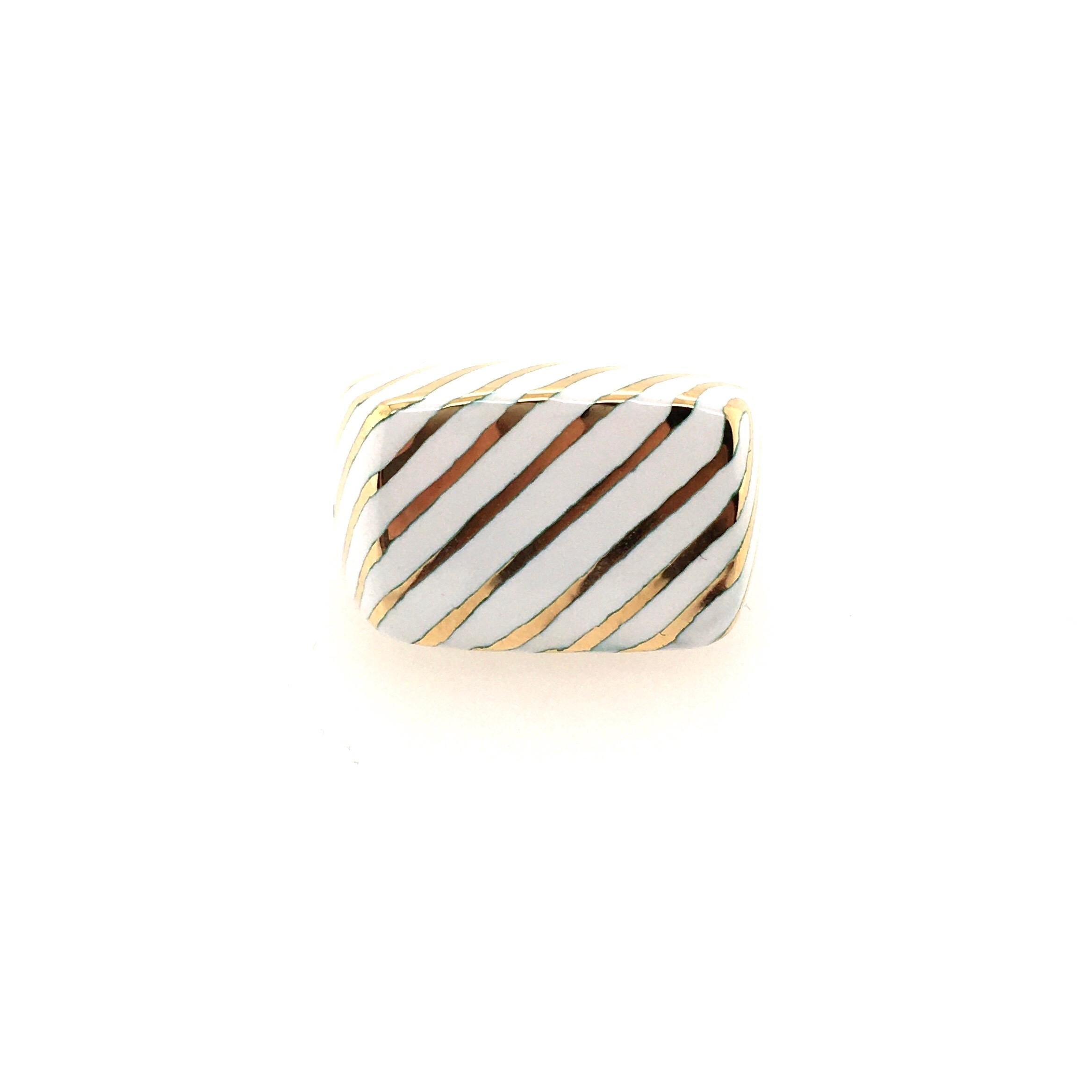 An 18 karat yellow gold and enamel ring. David Webb. Of squared design, decorated with stripped white enamel. Size 6 1/2 (with sizer), gross weight is approximately 22.2 grams. Stamped Webb. 