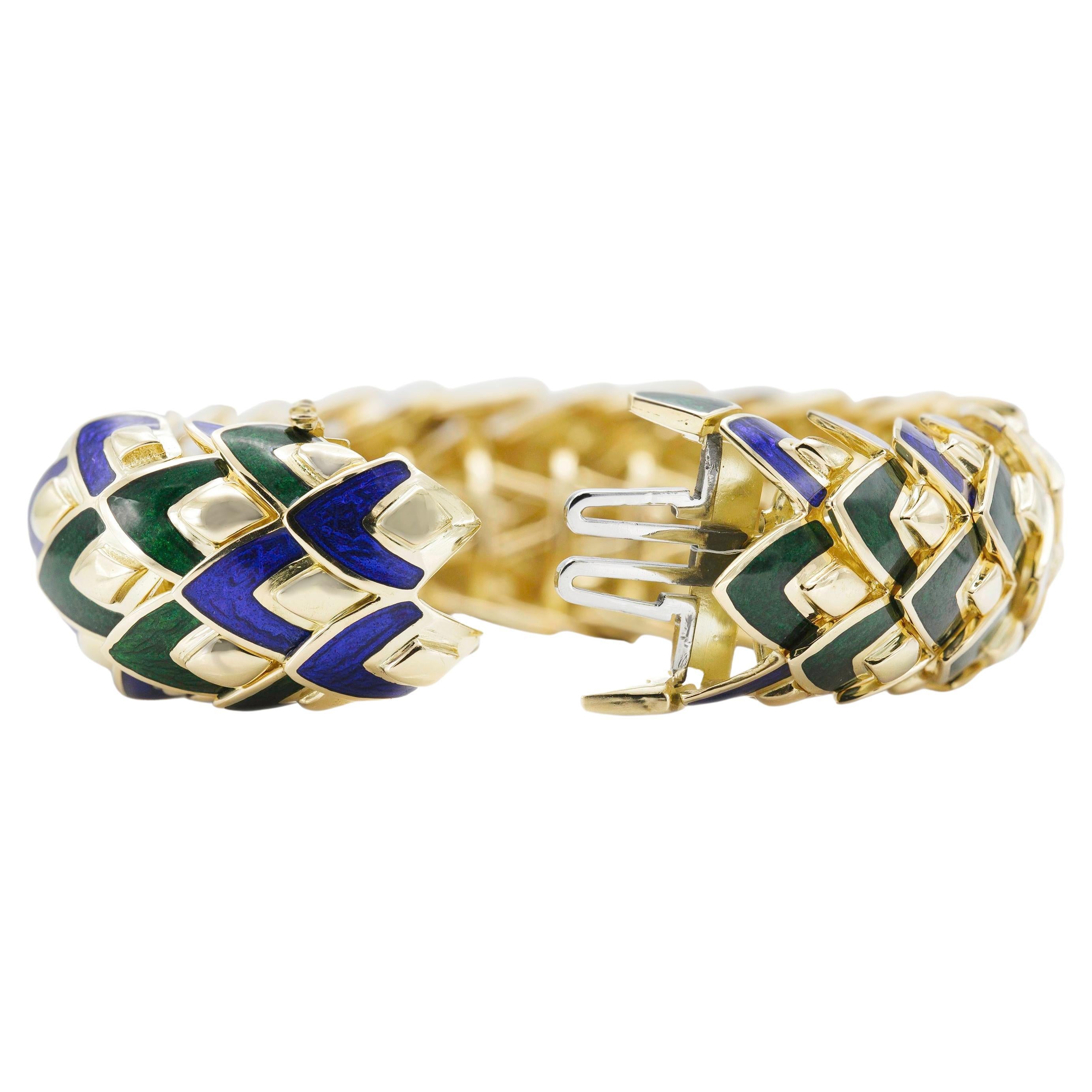 Finely crafted in 18K yellow gold featuring blue and green enamel on the scale-like links. 
Size 6 1/2 inches.
Signed by David Webb. 
Matching pin is also available.