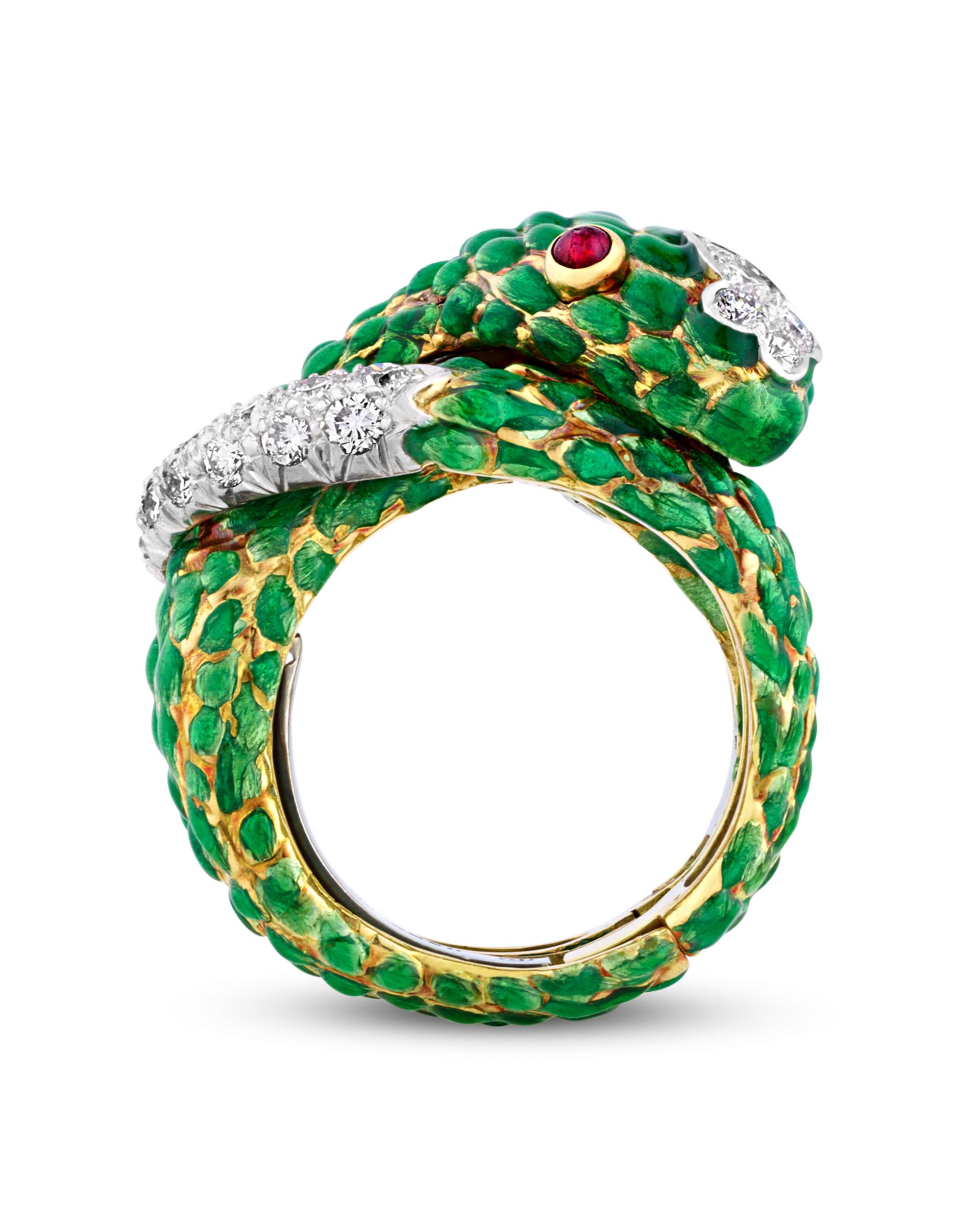 Slithering with sophistication, this striking snake ring is a masterpiece by David Webb. Vibrant green enamel scales wrap gracefully around the finger, accented by gleaming round brilliant cut diamonds and cabochon rubies that form the creature’s