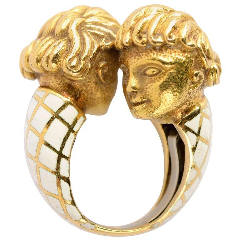 A beautiful enamel and 18 karat yellow gold bypass ring by David Webb featuring the heads of two cherubs. Made in the USA, circa 1970. Size 9.5.