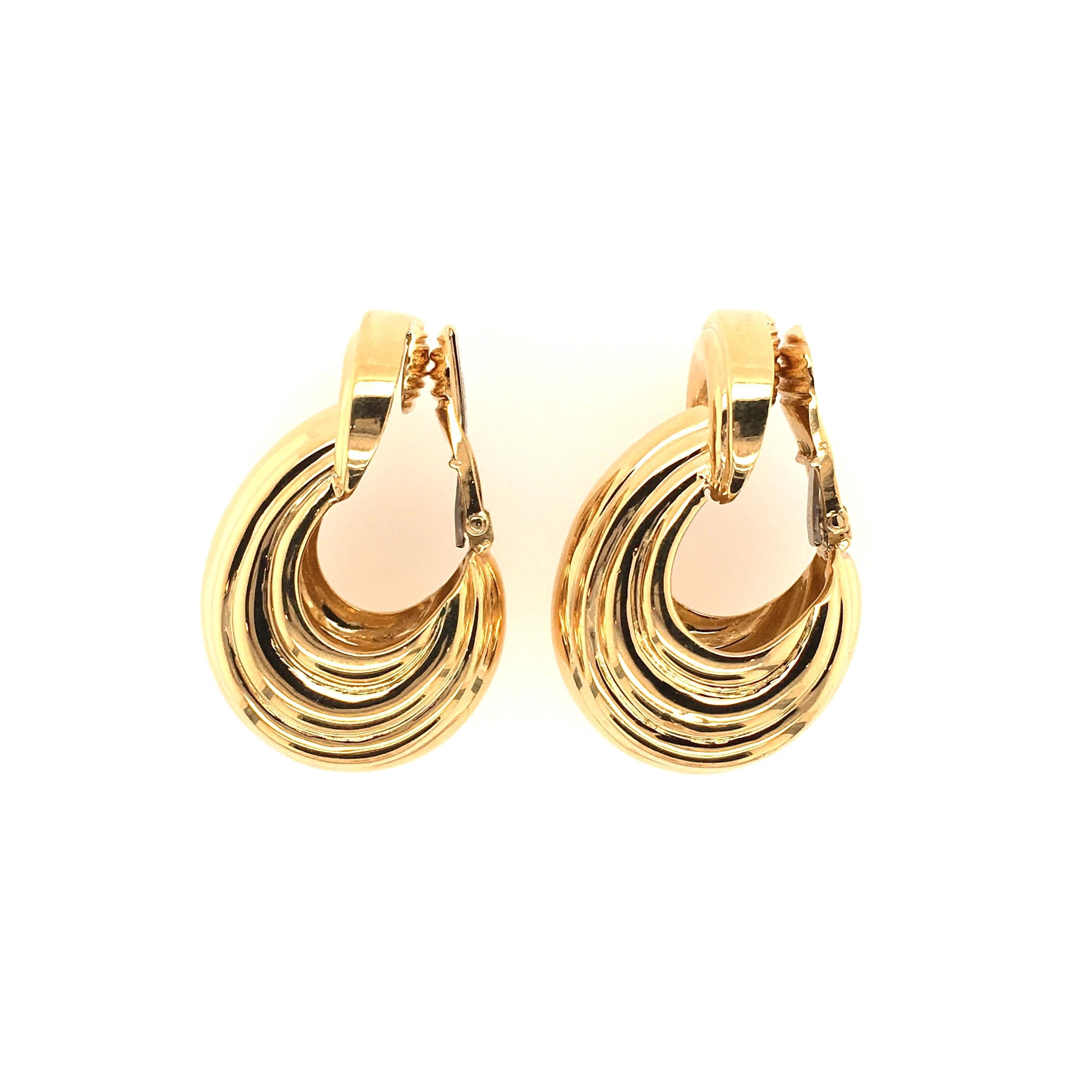 A pair of 18 karat yellow gold earrings. David Webb. Designed as a fluted bombe half hoop, from a similarly designed half moon surmount. Length is approximately 1 1/2 inches, gross weight is approximately 52.7 grams. Stamped Webb, 18K. 